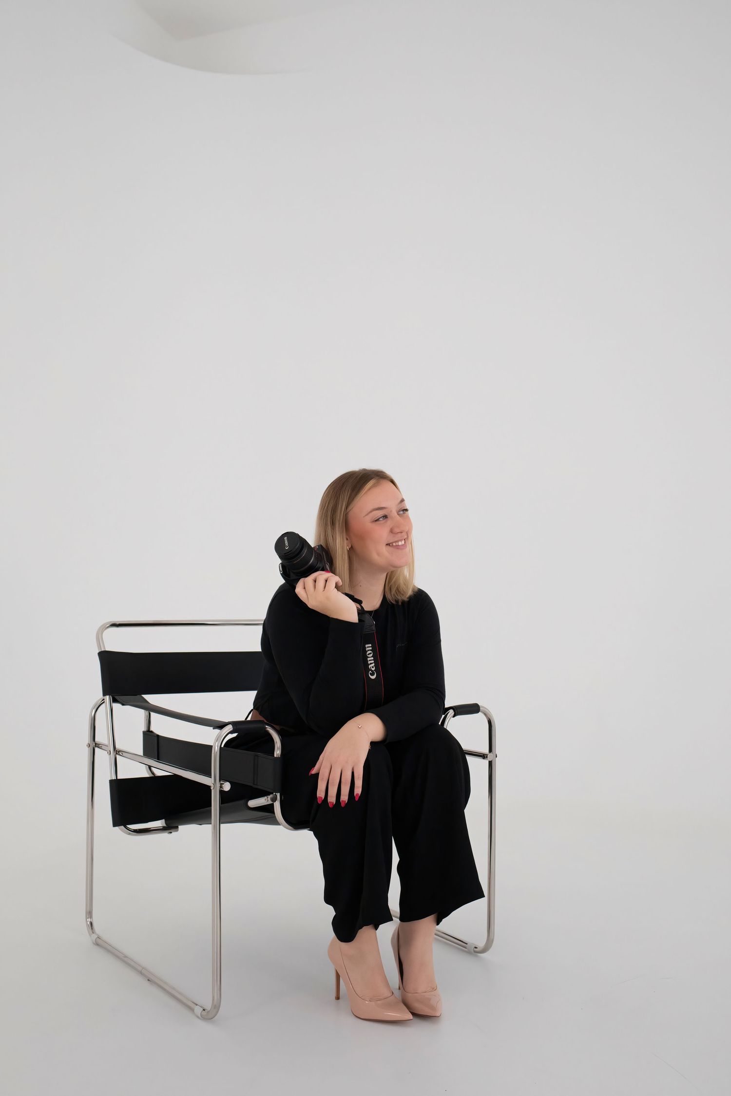 Image of Becka holding camera in photography room