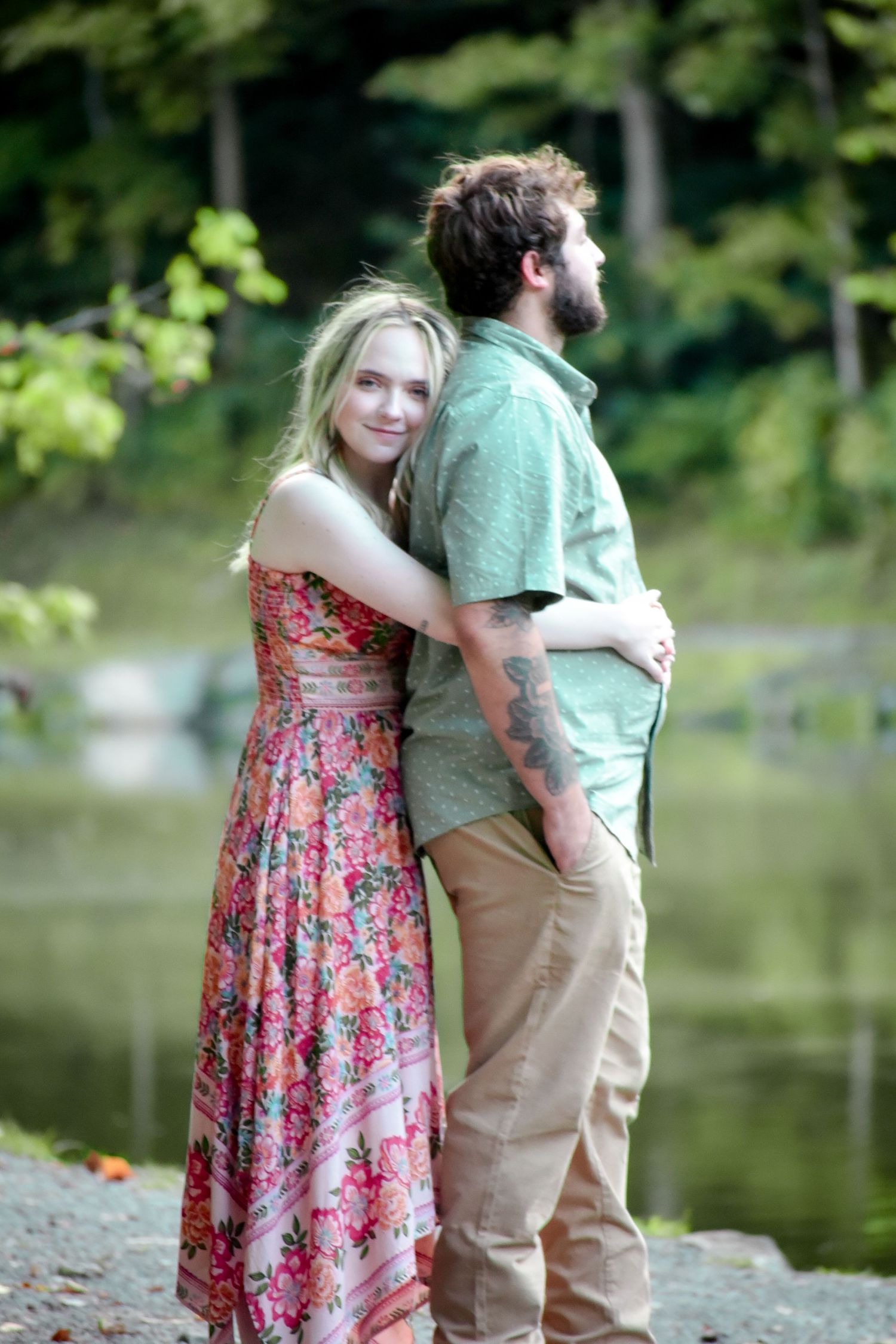 A romantic lakeside photoshoot featuring a floral dress and casual summer attire.