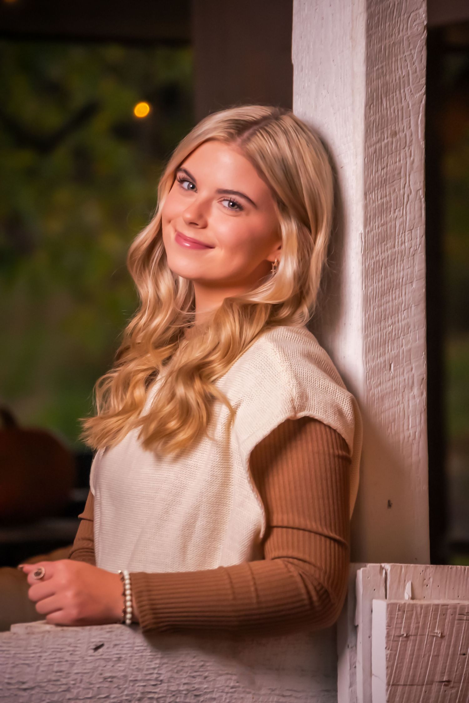 Casual portrait session with warm lighting and cream colored sweater.