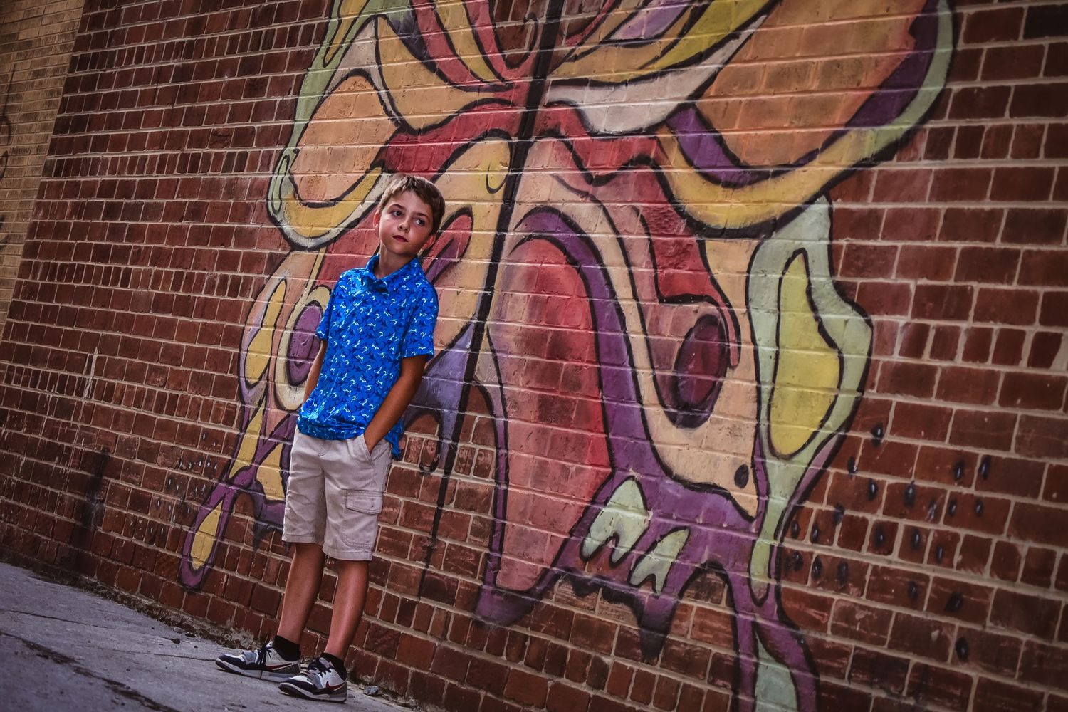Colorful street art mural painted on brick wall with abstract designs.