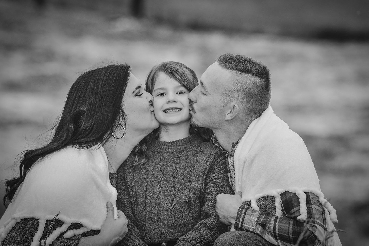Couple laughing together in black and white portrait.