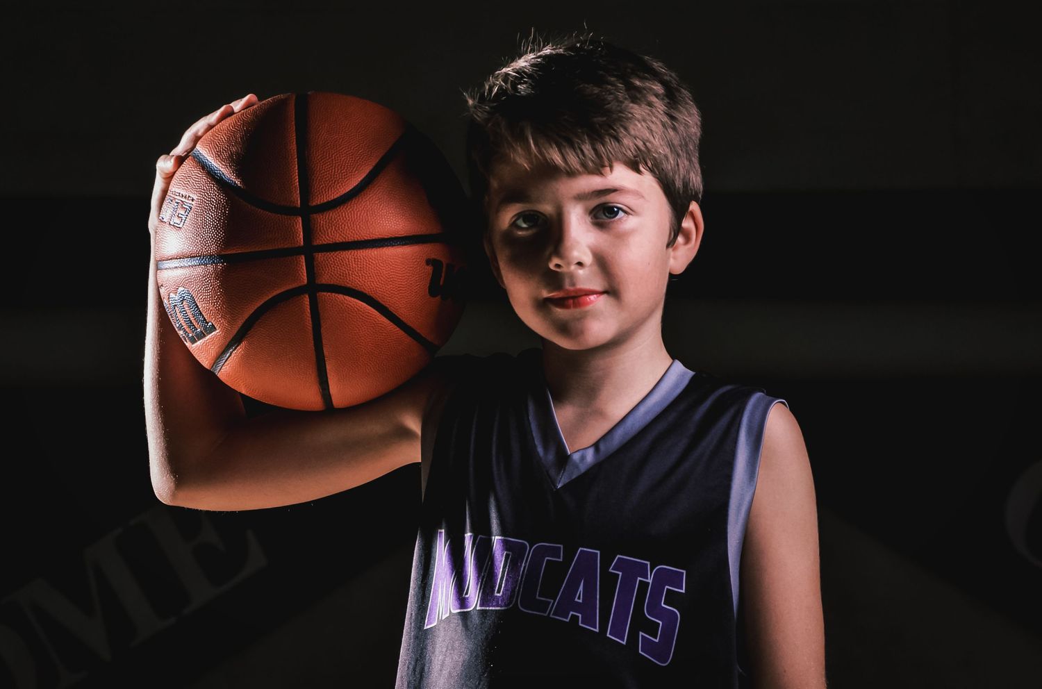 A series of six basketball-themed portraits with dramatic lighting against a dark background.