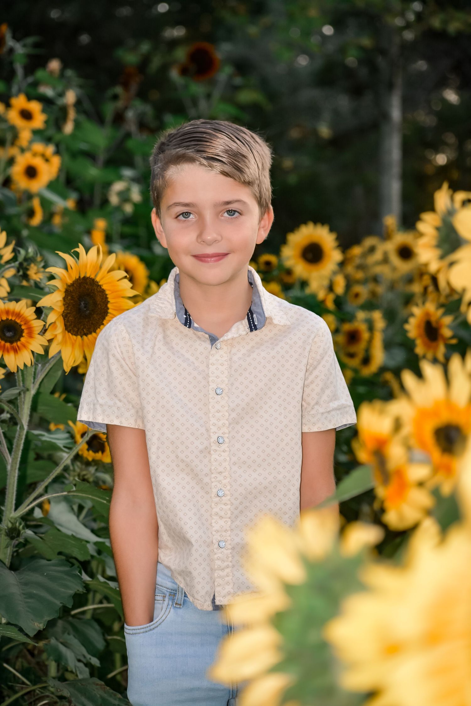 White polka dot shirt against vibrant yellow sunflowers in a garden setting.