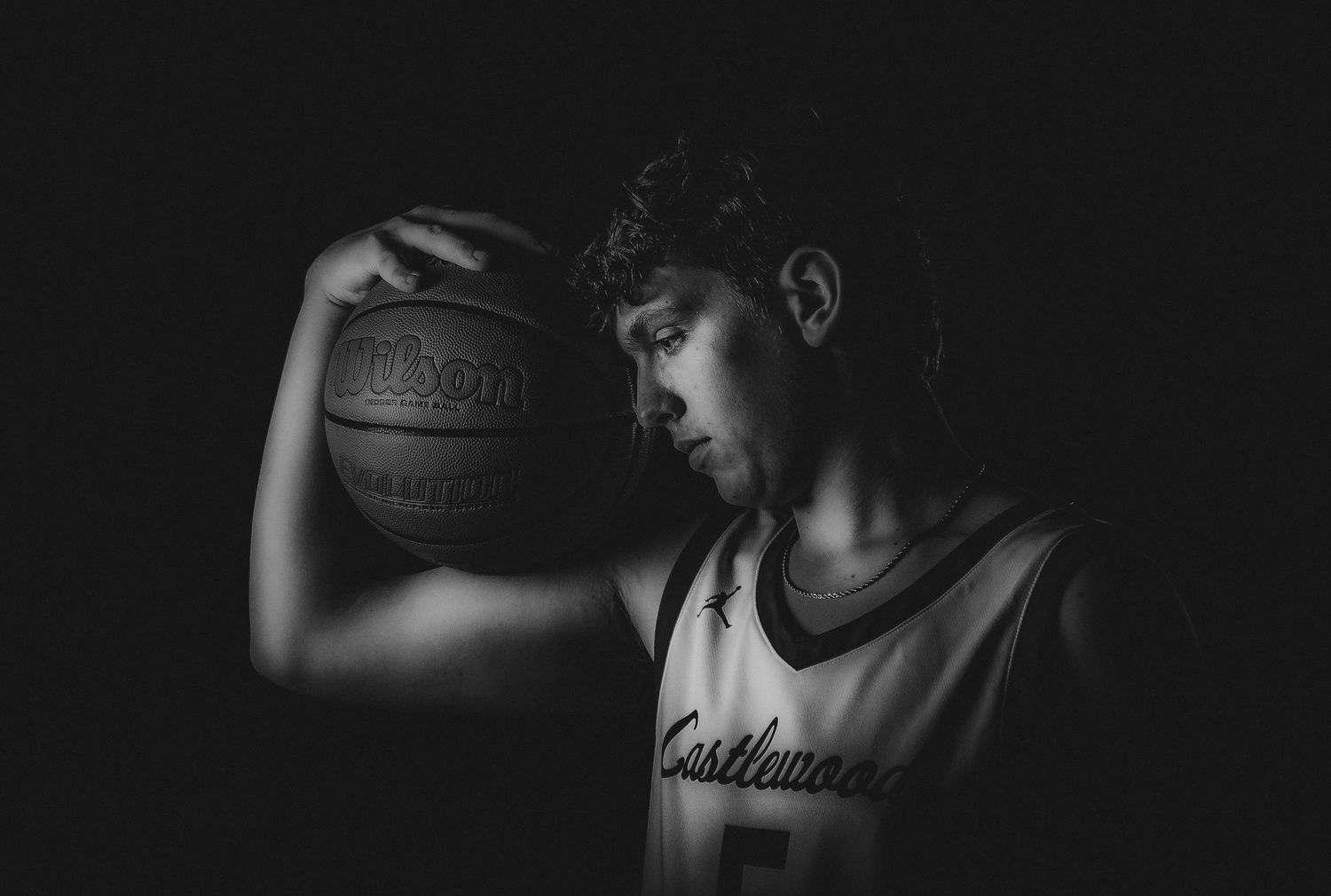 Dramatic low key lighting setup for sports photography in a dark studio.