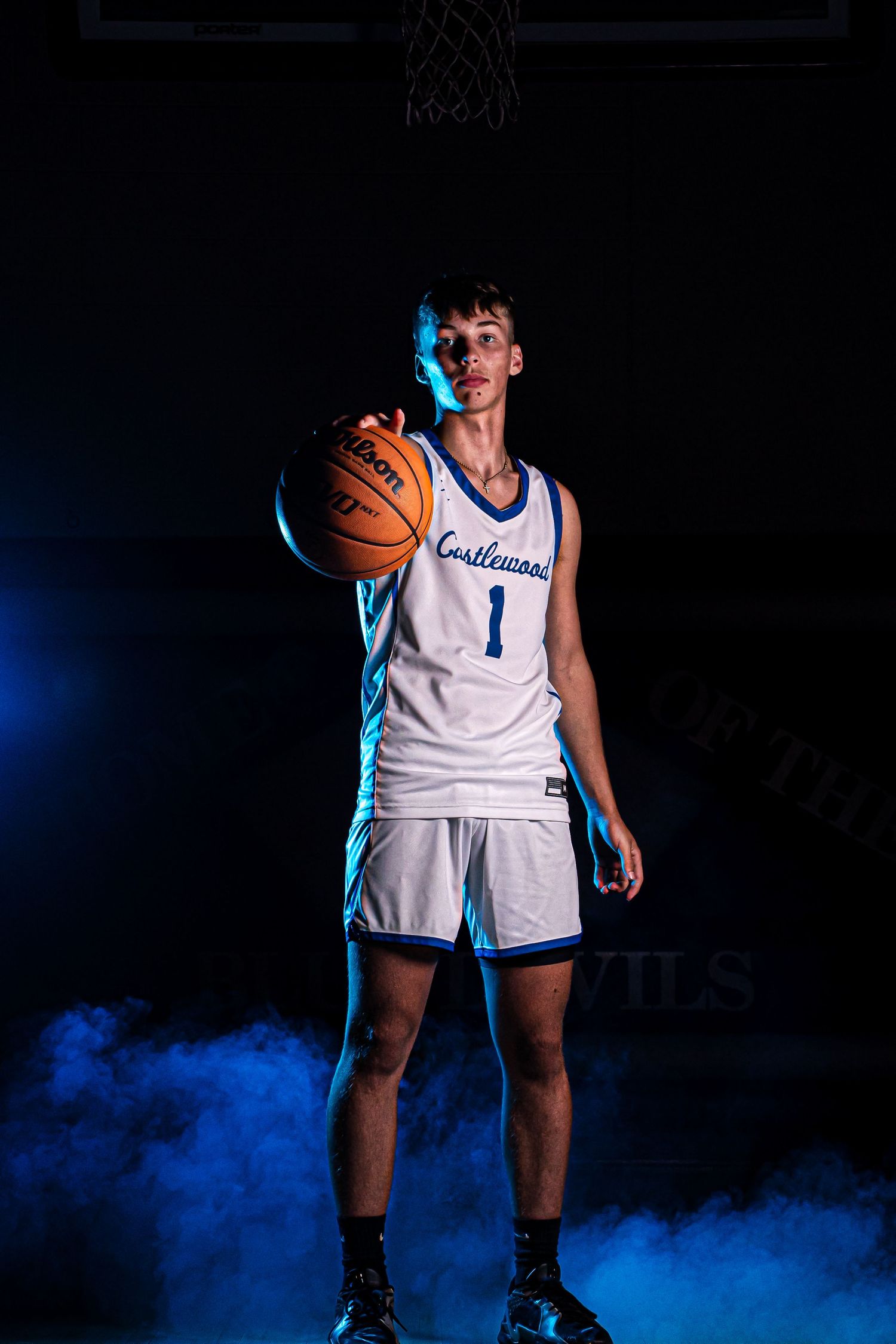 Basketball player in number 1 jersey poses with dramatic blue smoke effect.