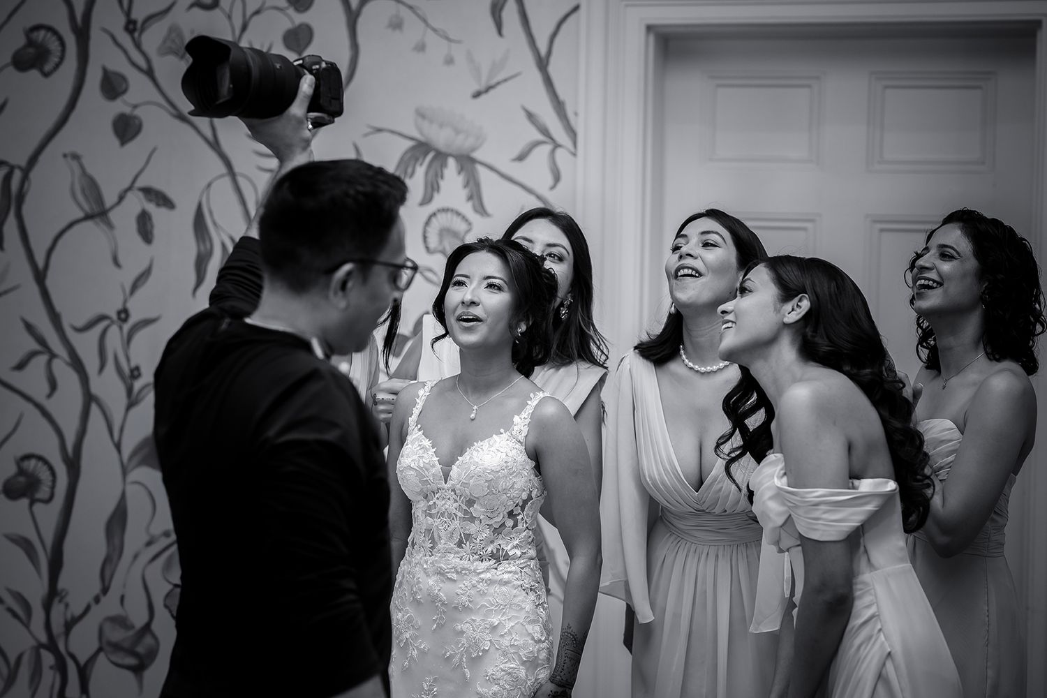 Elegant wedding celebration with floral wall decor and festive dancing.