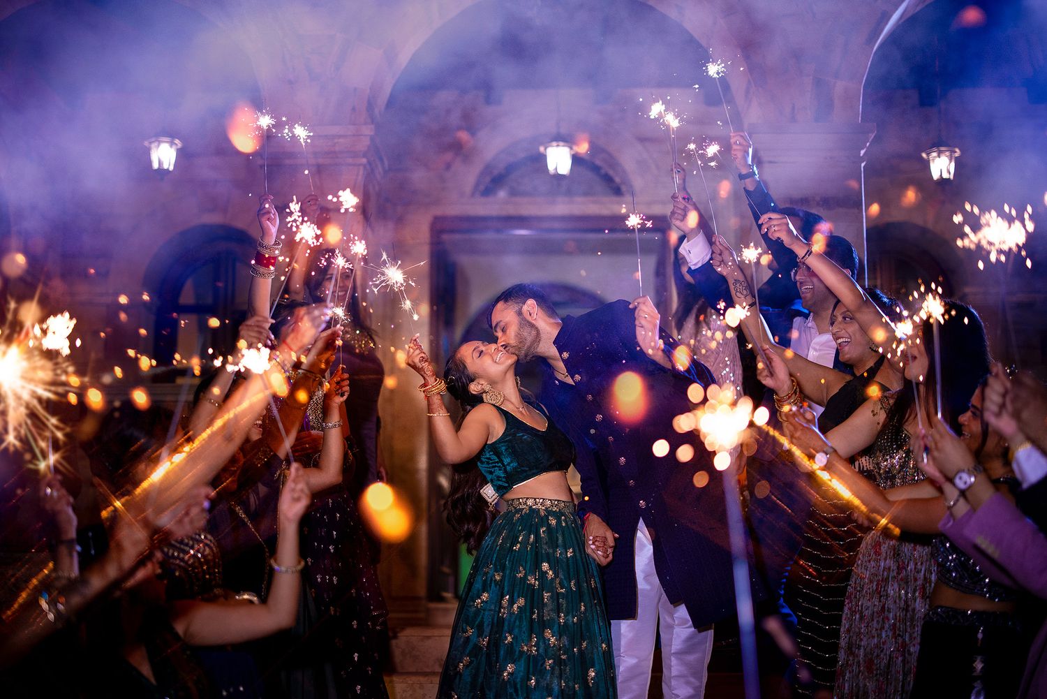 Party crowd enjoys a celebration with sparklers creating a magical atmosphere.