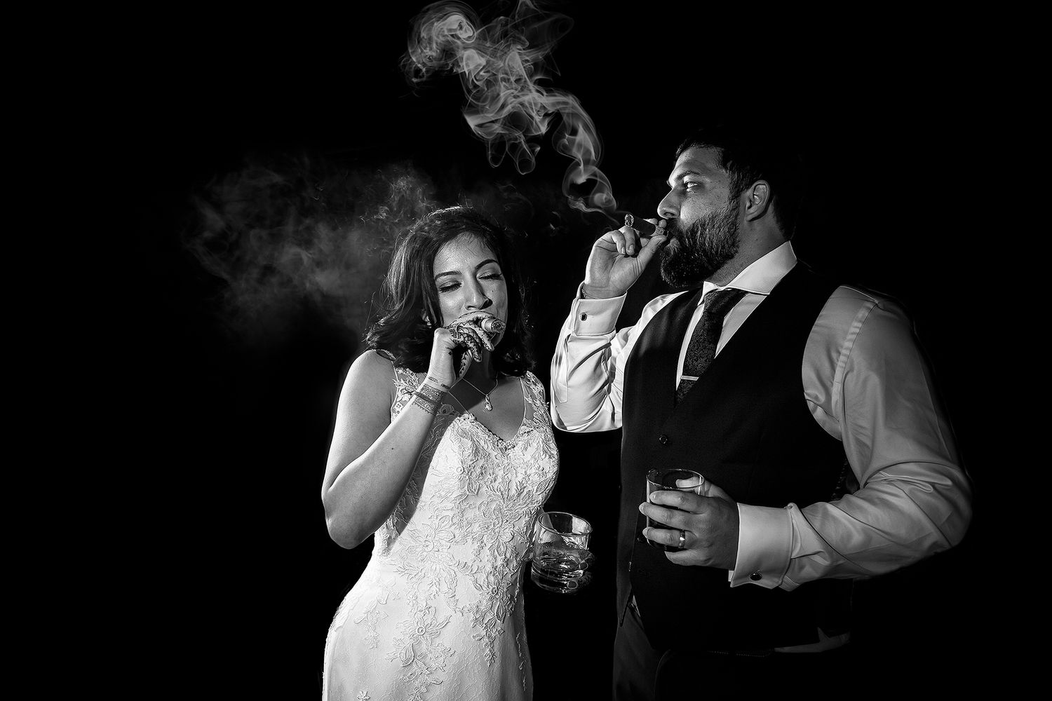Black and white photo of wedding guests dancing and enjoying reception party.