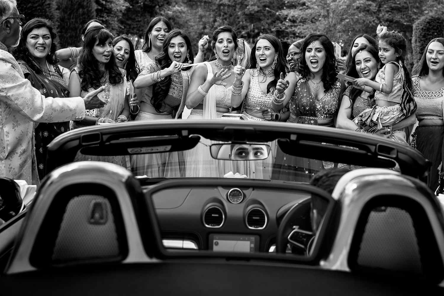 A group celebrates joyfully outdoors during a special event with a festive atmosphere.