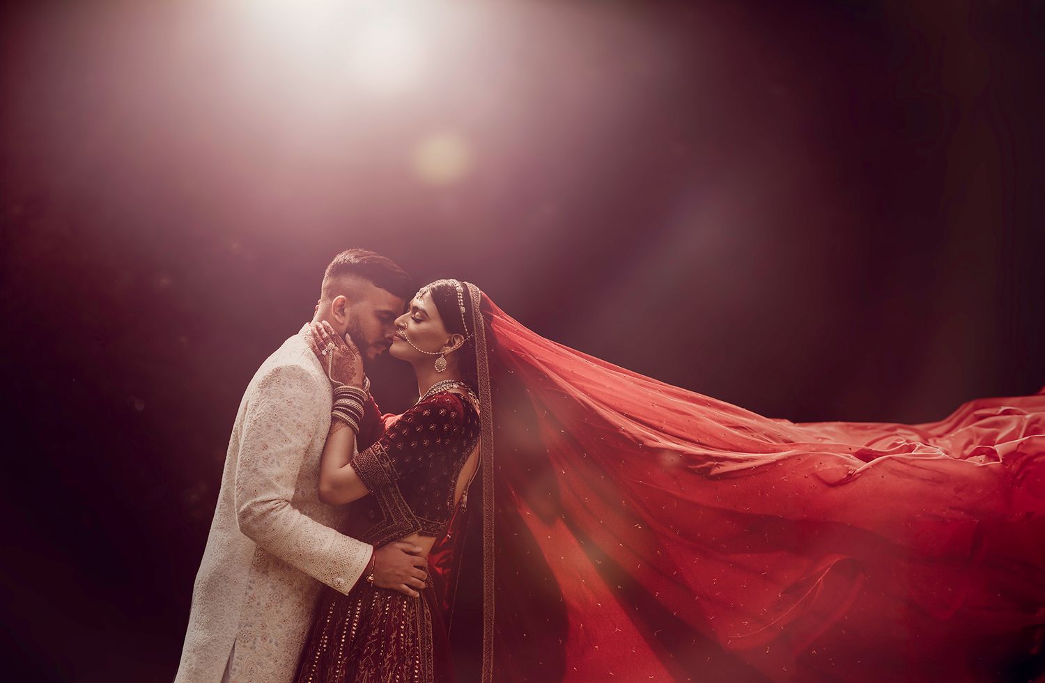 Dramatic wedding photography series with flowing red fabric and moody lighting effects.