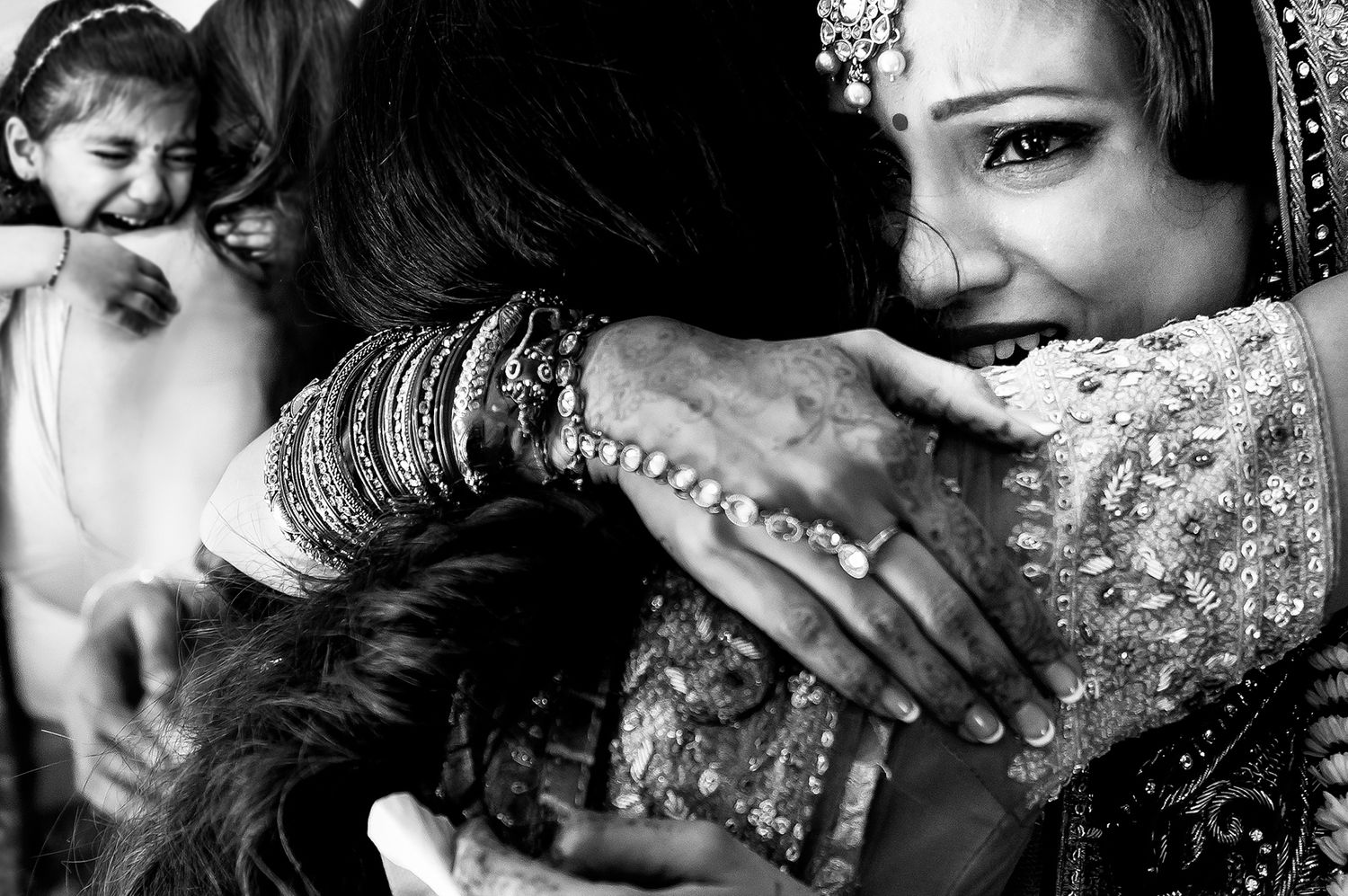 Intimate black and white portraits capturing emotional moments during Indian wedding ceremony.