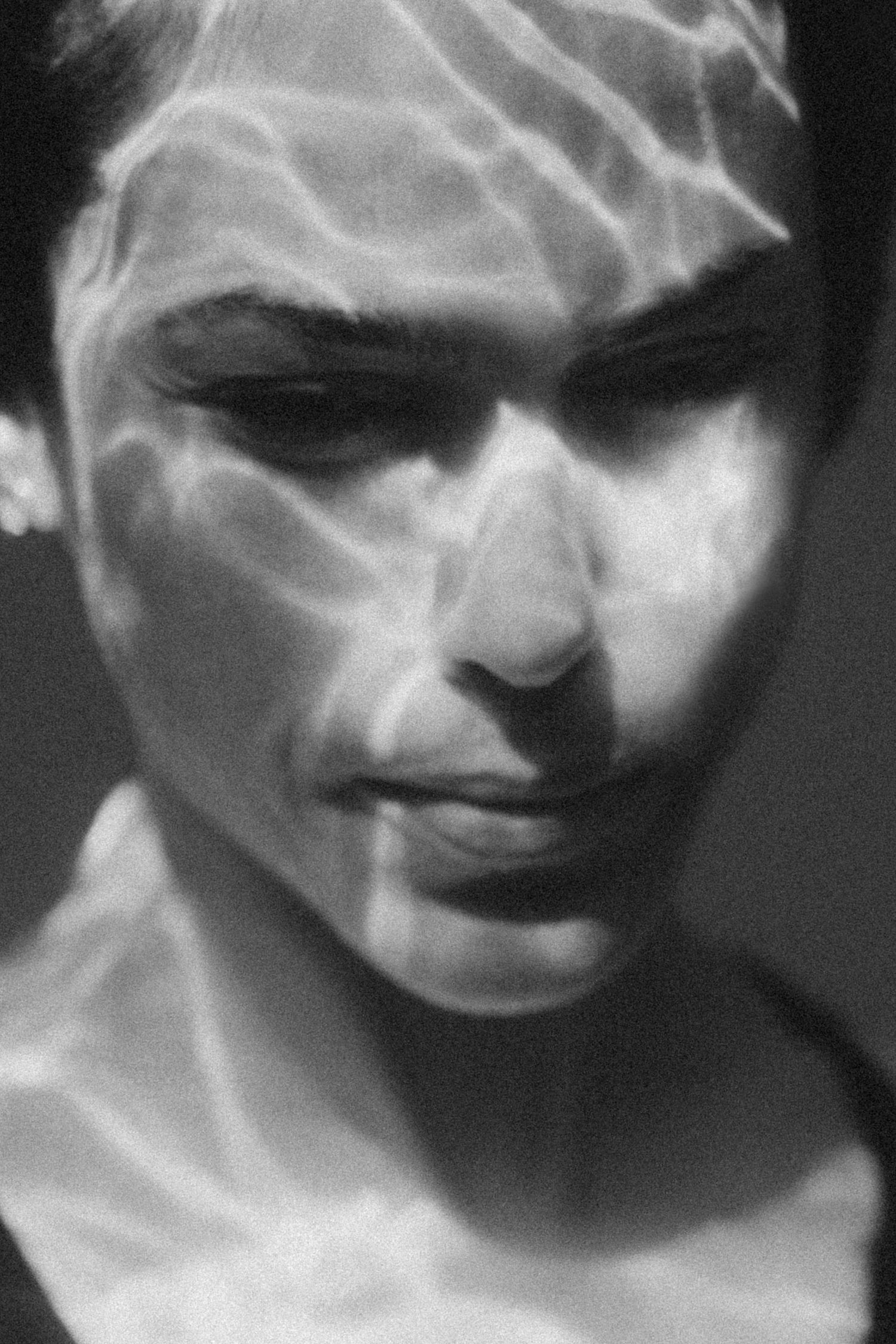 Abstract black and white portrait with ethereal smoke-like effects creating a dreamy atmosphere.