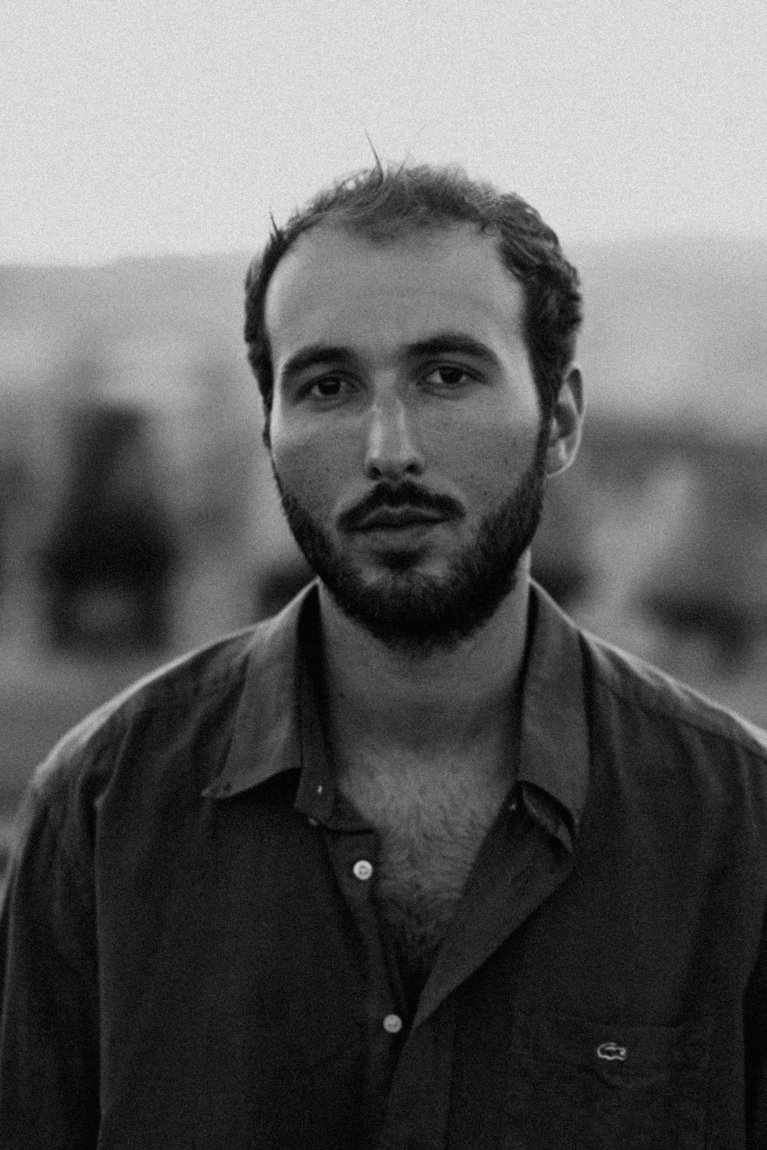 Black and white portrait series showing different facial expressions with beard.