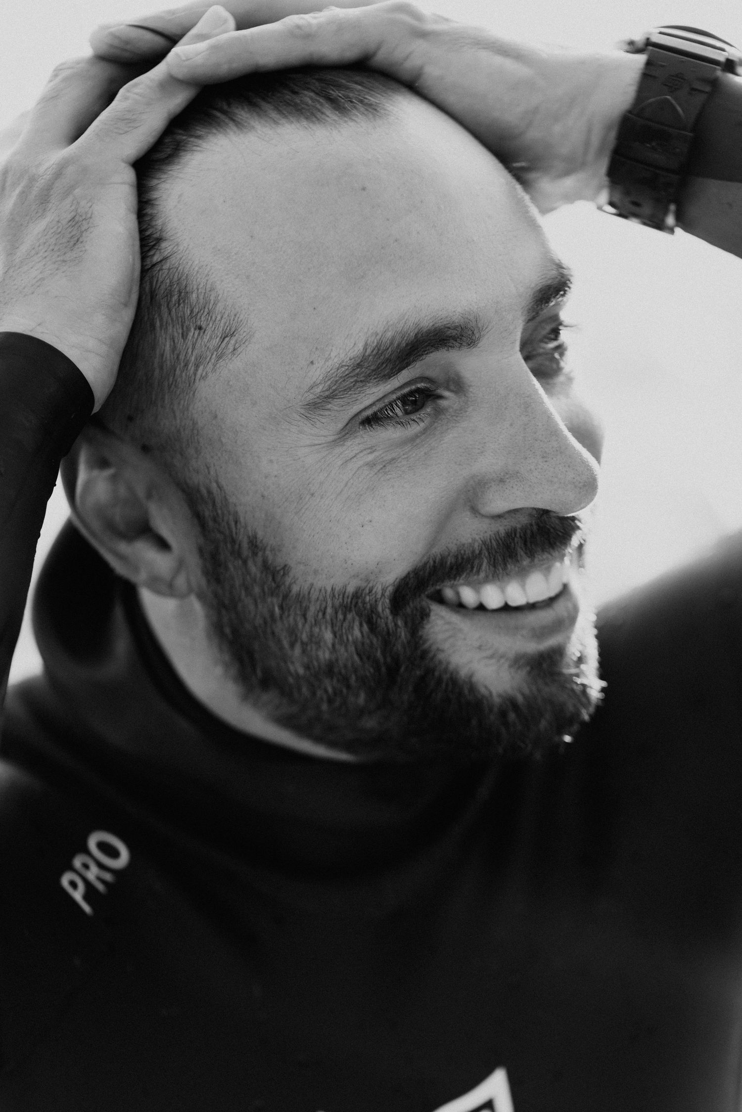 Black and white portrait series showing joyful expressions.