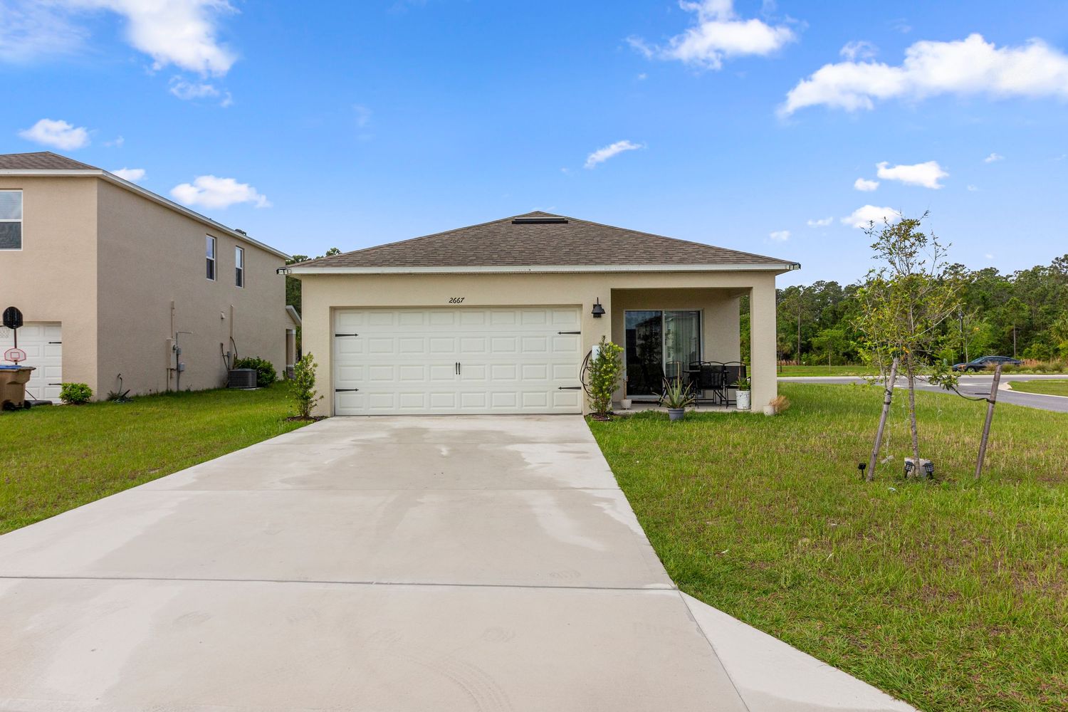 Single-family home exterior with driveway and garage in quiet Florida neighborhood