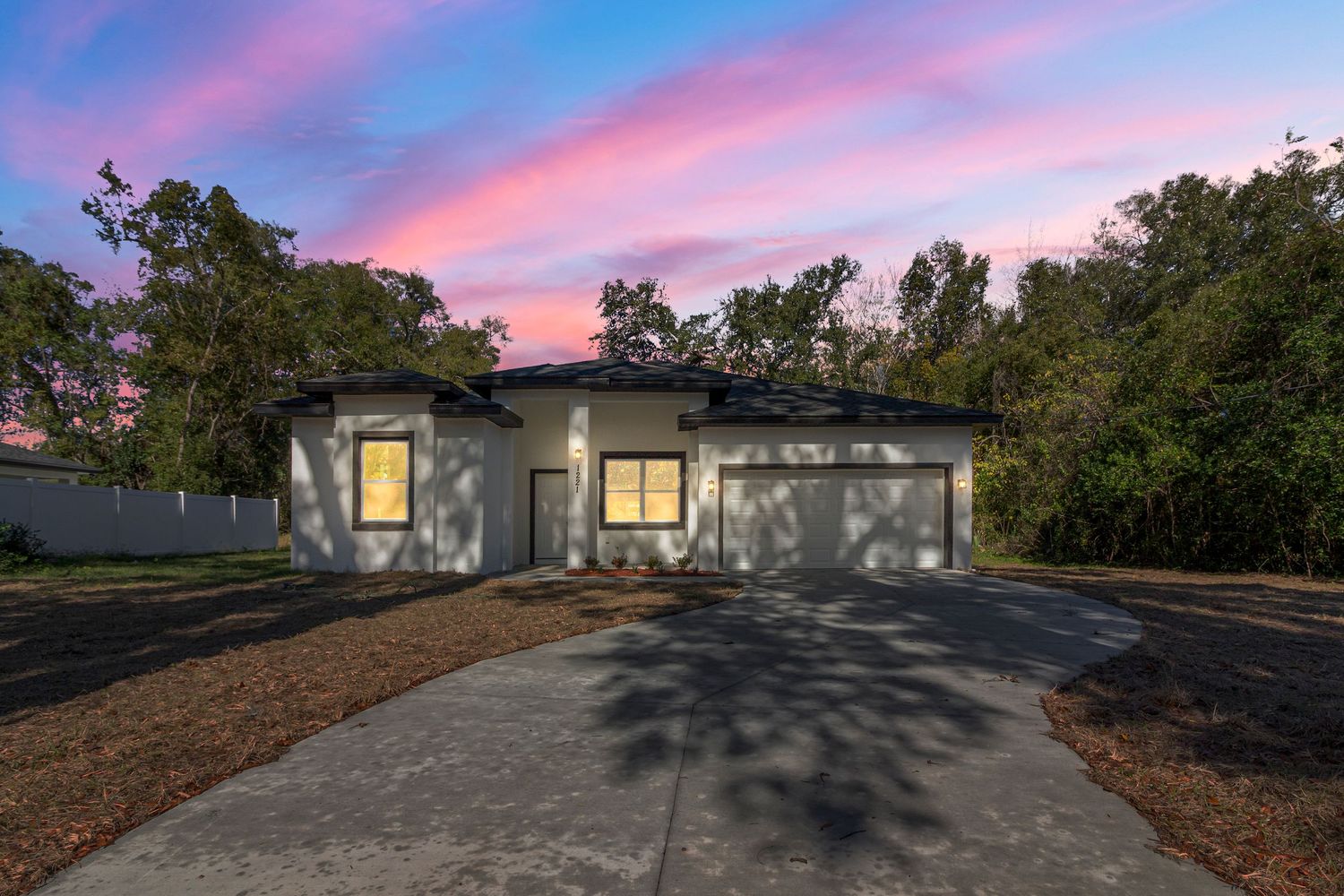Luxury home exterior at sunset with dramatic sky and driveway in Central Florida
