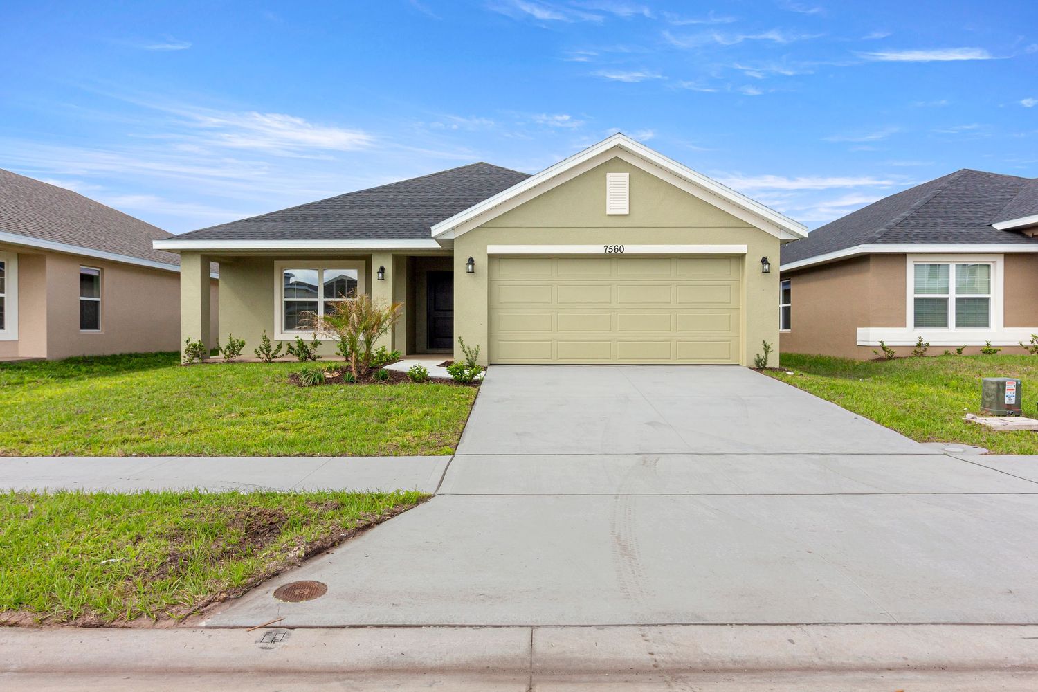 Front exterior of single-family home with garage and clean curb appeal in Florida