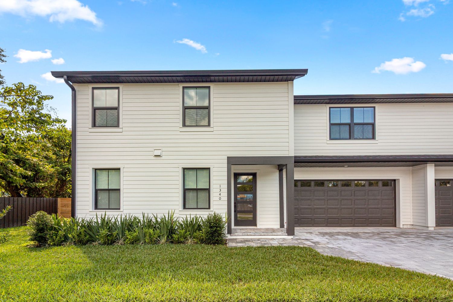 Modern Orlando Florida two-story home exterior with contemporary design, attached garage, and front lawn. Professional Orlando real estate.