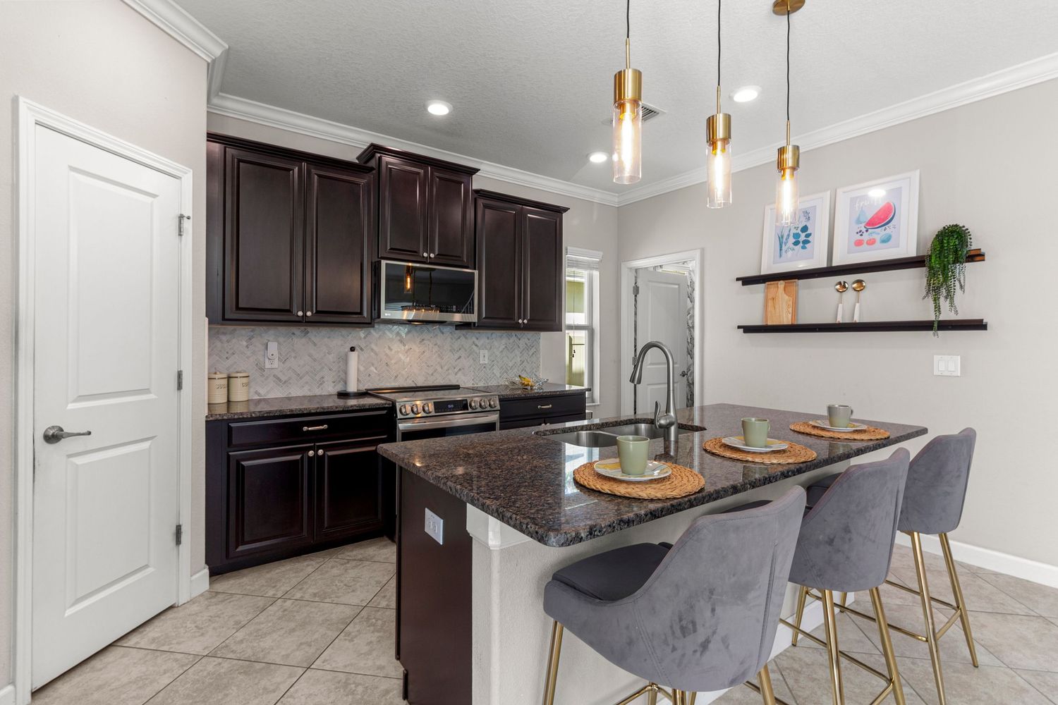 Luxury kitchen with granite countertops, bar stools, and modern finishes – real estate photography Central Florida