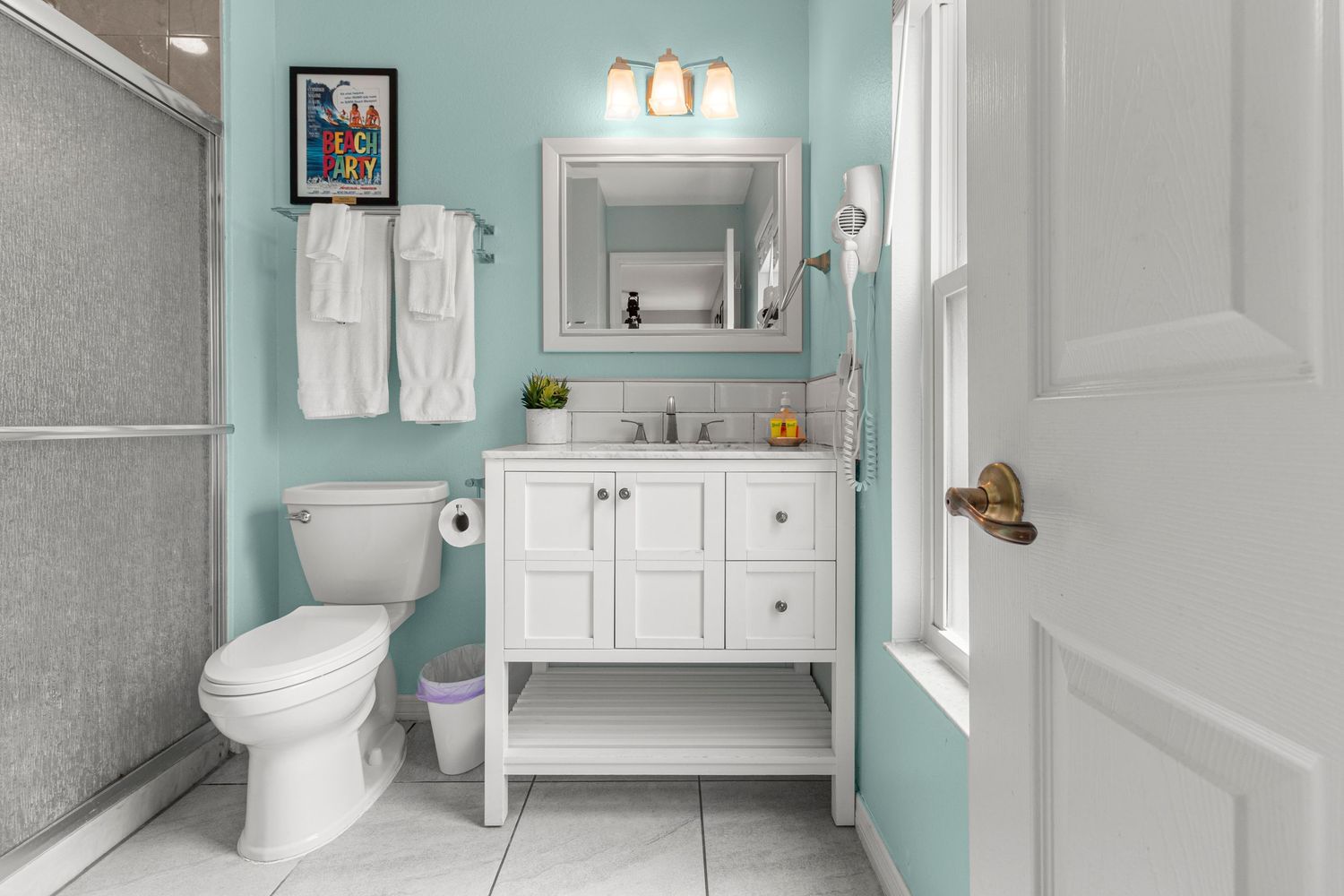Updated bathroom with elegant vanity and bright finishes captured through professional real estate photography.