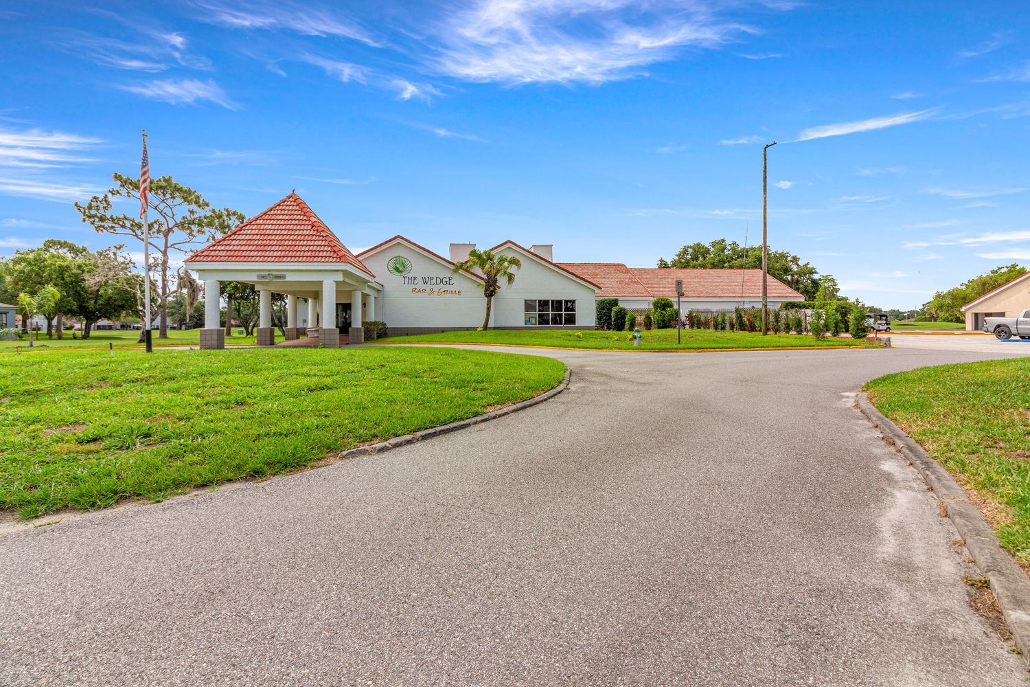 Central Florida luxury estate featuring a private driveway and expansive grounds captured with professional real estate photography.
