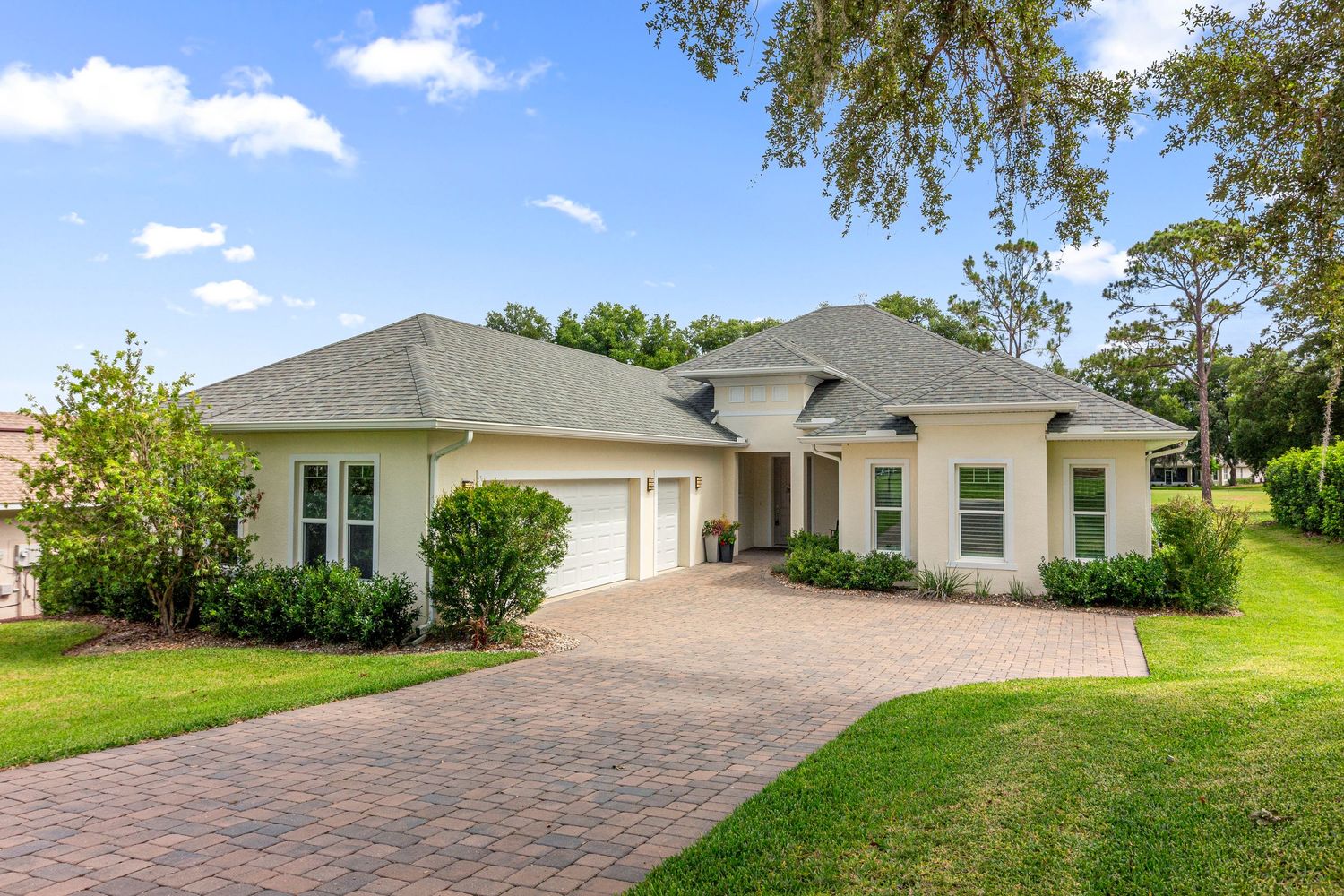 Bright Central Florida home exterior with clean landscaping, driveway view, and professional real estate photography.