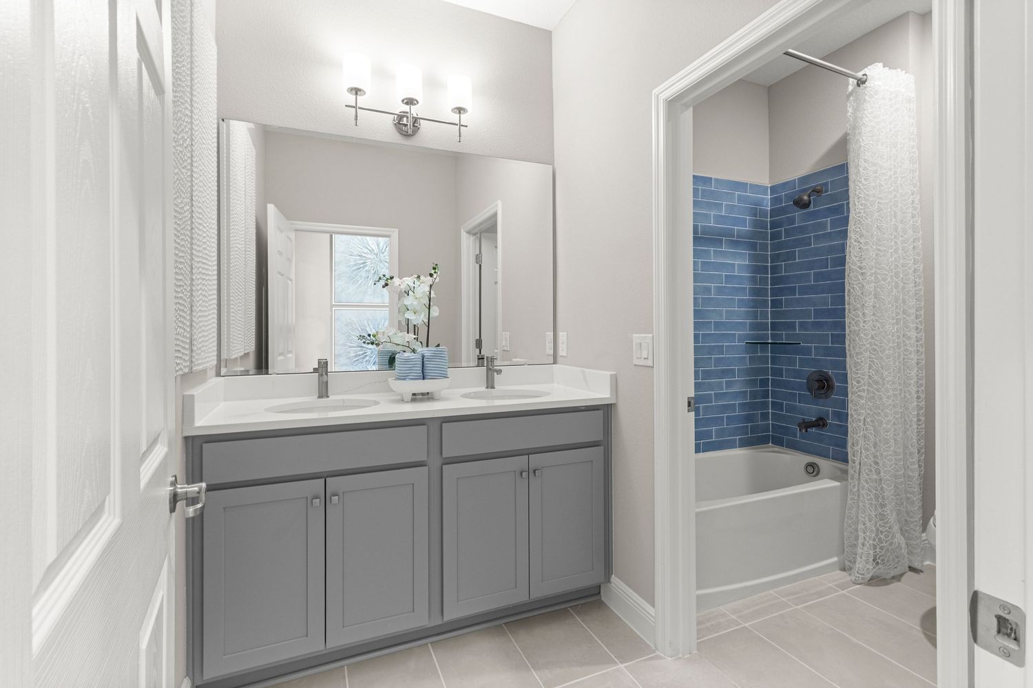 Elegant Clermont Florida bathroom photography featuring gray vanity cabinets, spacious walk-in shower with glass enclosure, and modern.