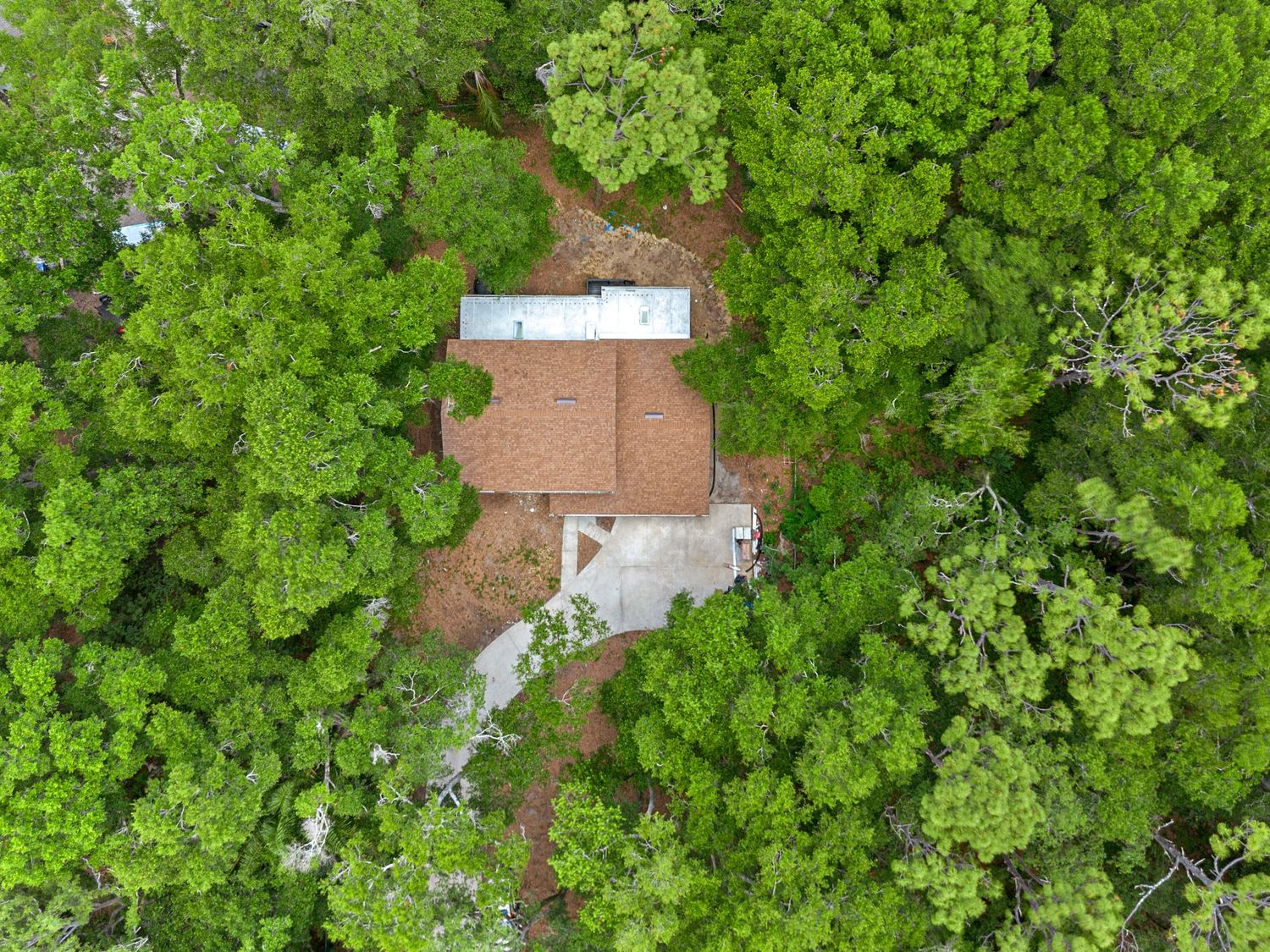 Aerial drone photography of a secluded Central Florida estate surrounded by mature trees and natural landscape.