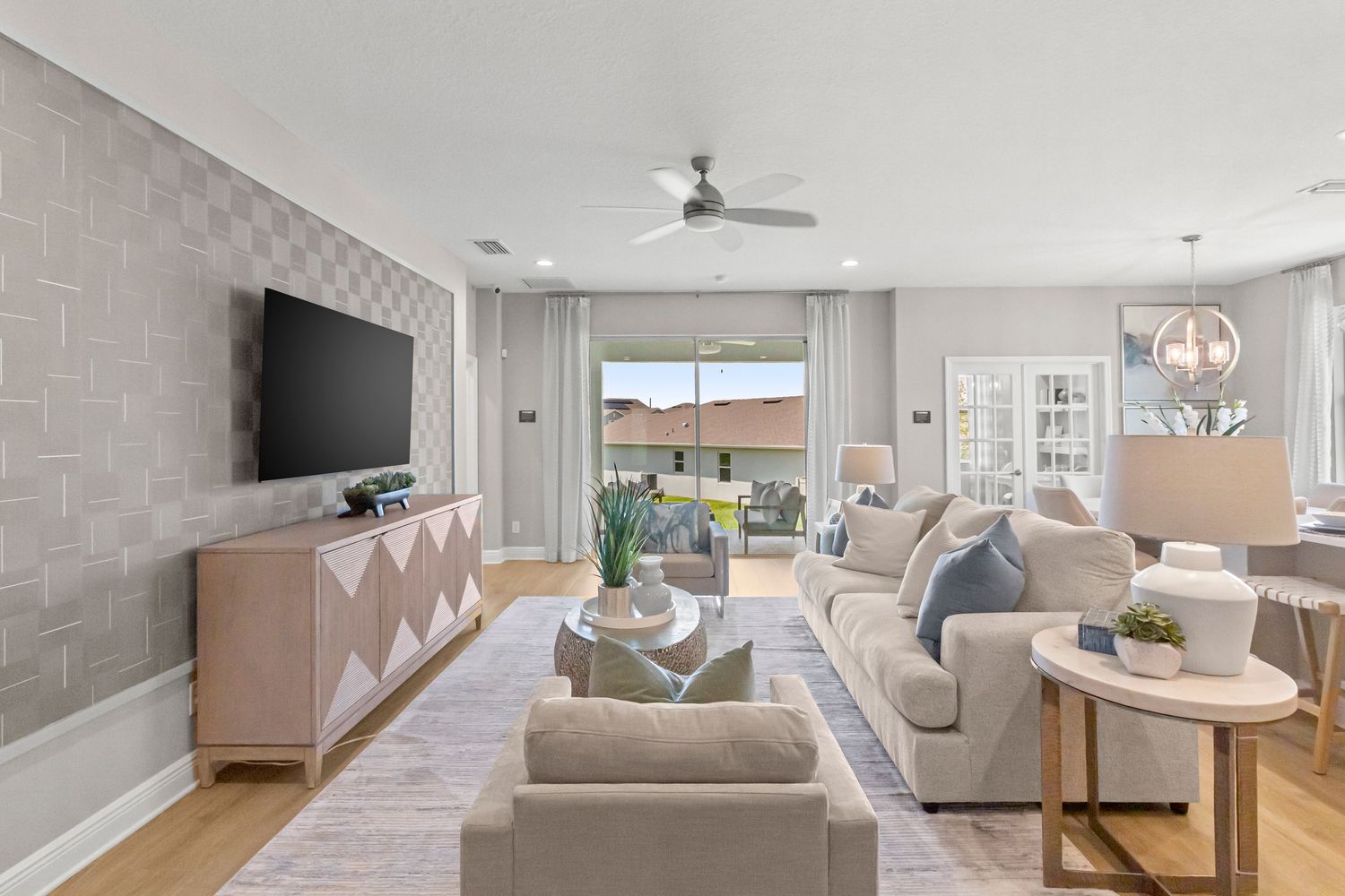 Modern Orlando Florida living room with open-concept design, neutral furniture, accent pillows, and seamless kitchen flow. Professional.