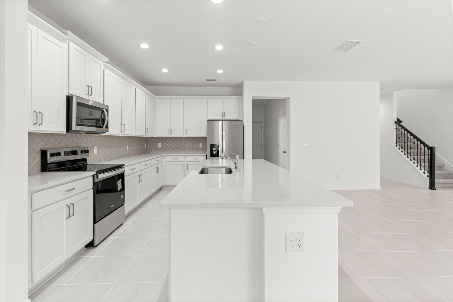 Sleek Groveland Florida modern kitchen with white minimalist design, stainless steel appliances, and clean lines. Professional Lake County.