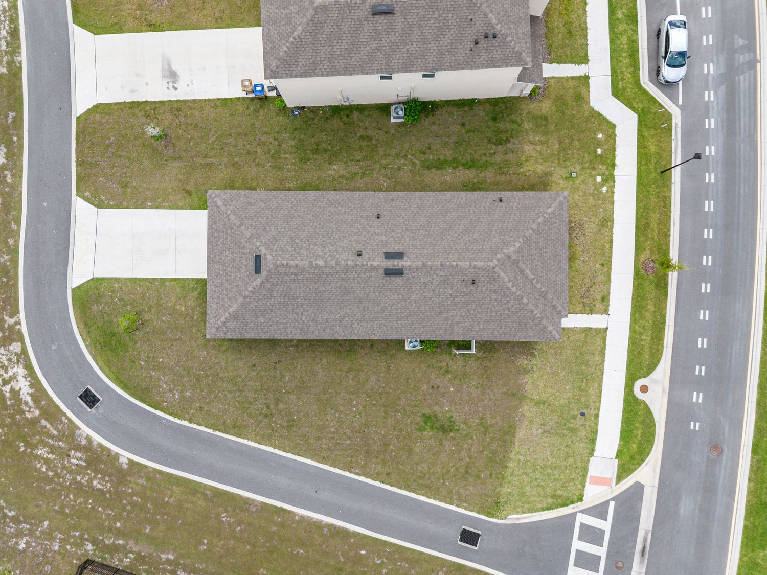 Top-down aerial of home lot and street layout in suburban Florida community