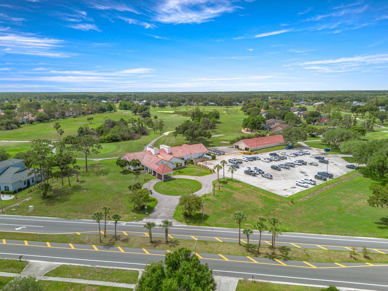 Aerial drone photo showing Central Florida amenities, roads, green space, and surrounding neighborhood views.
