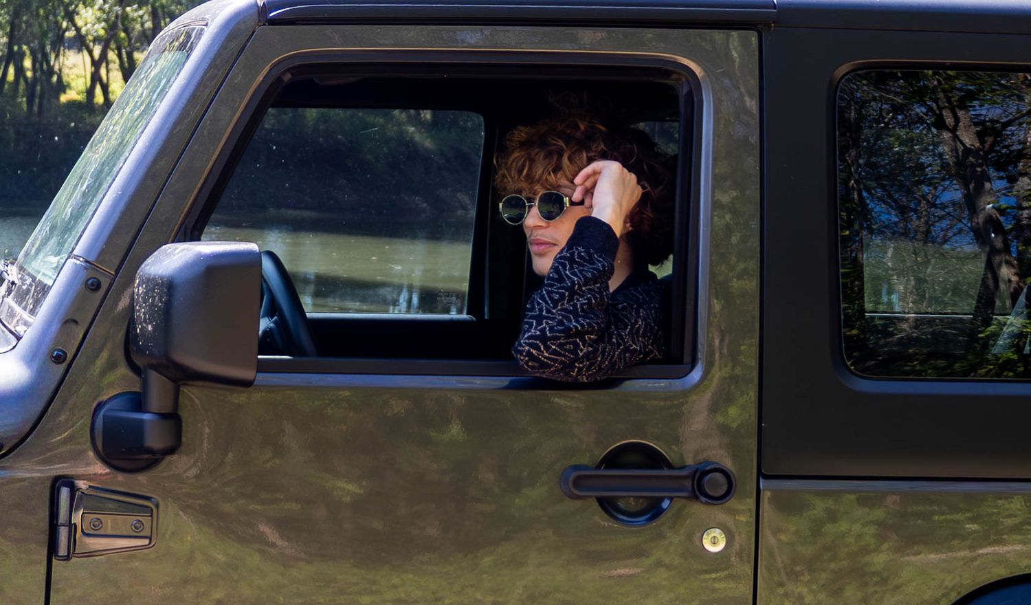 This senior driving his jeep for his senior session in Aldrich MO