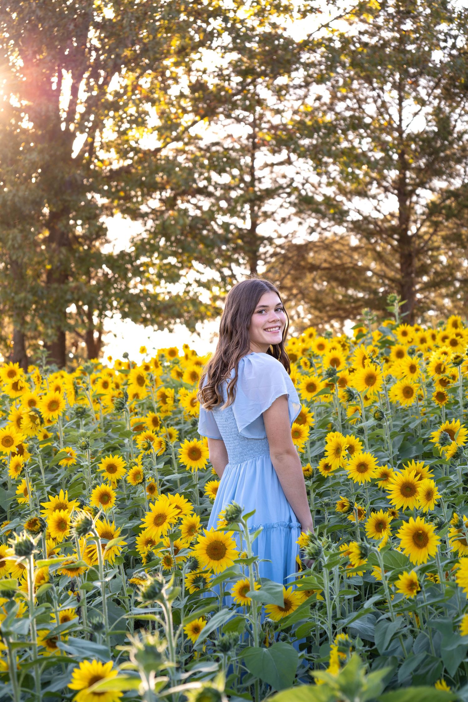 Senior dancing in sunflower field near Springfield MO for her photography session
