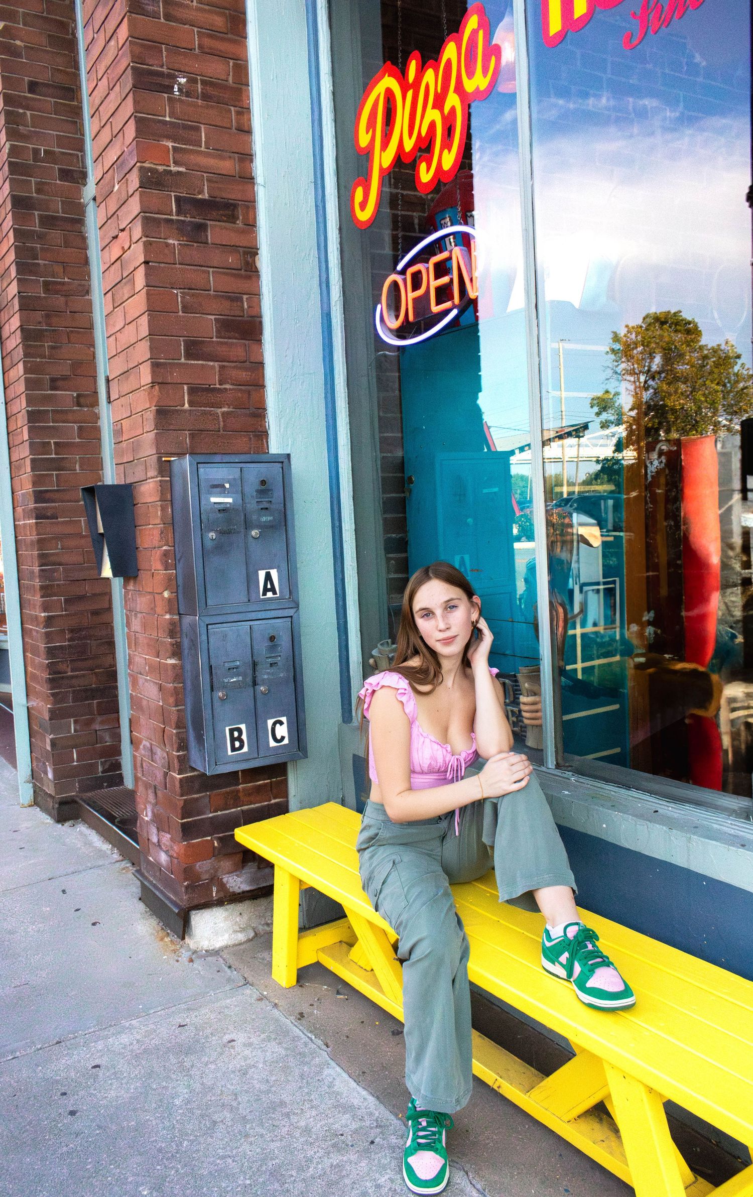 Senior Girl from Springfield MO sitting near Pizza House on Commercial Street for her senior sessions with Refined by Fire Photography