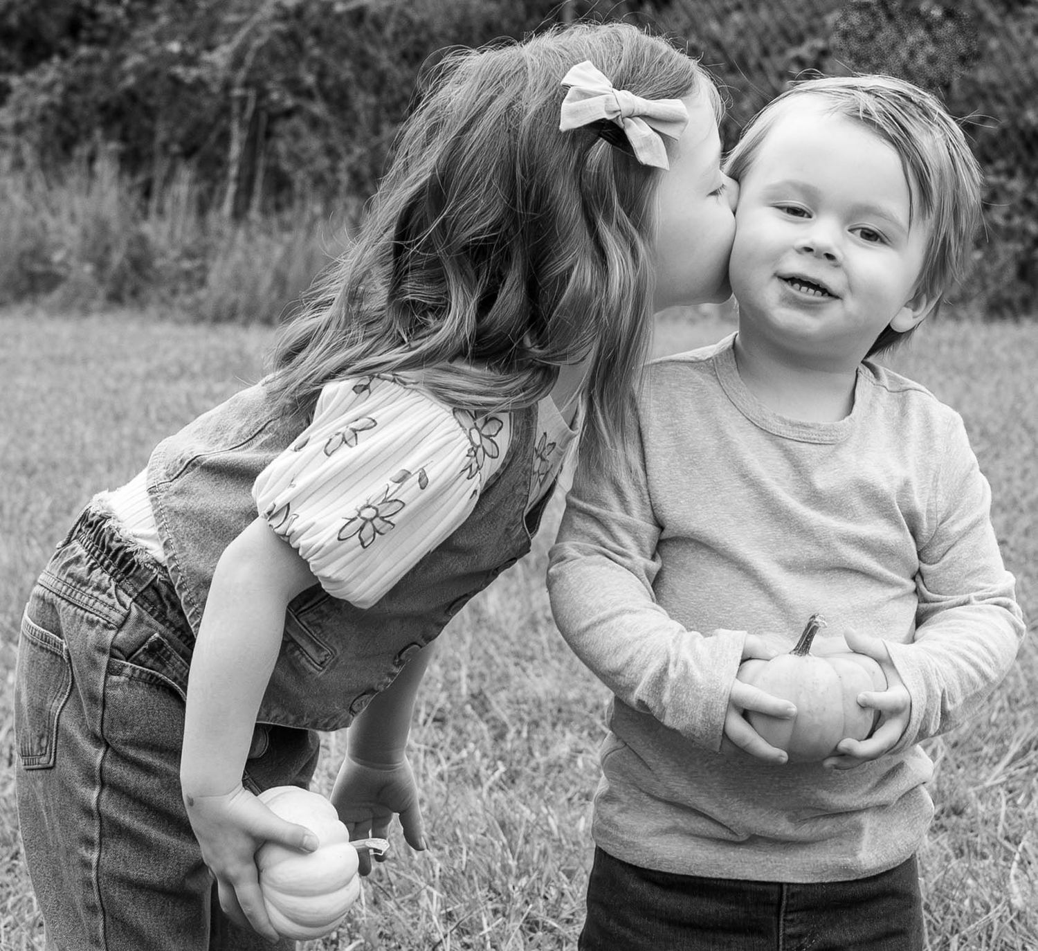 Siblings playing in the fall during a lifestyle family photoshoot for a album in Strafford MO