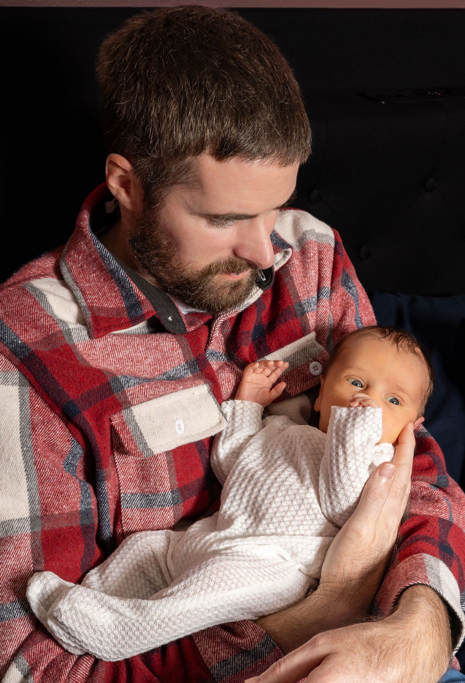 Dad holding new born in willard MO family lifestyle session