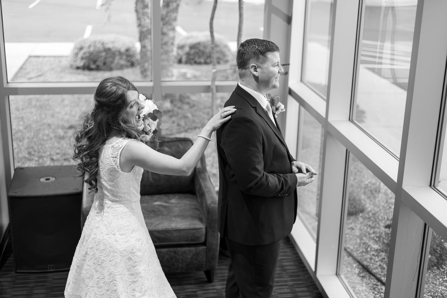 bride tapping on grooms shoulder before the first look in Strafford mo located in Southwest MO