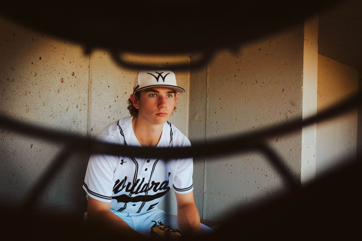 Willard Baseball senior hanging in the dug out during his senior session with top photographer Refined by Fire Photographer