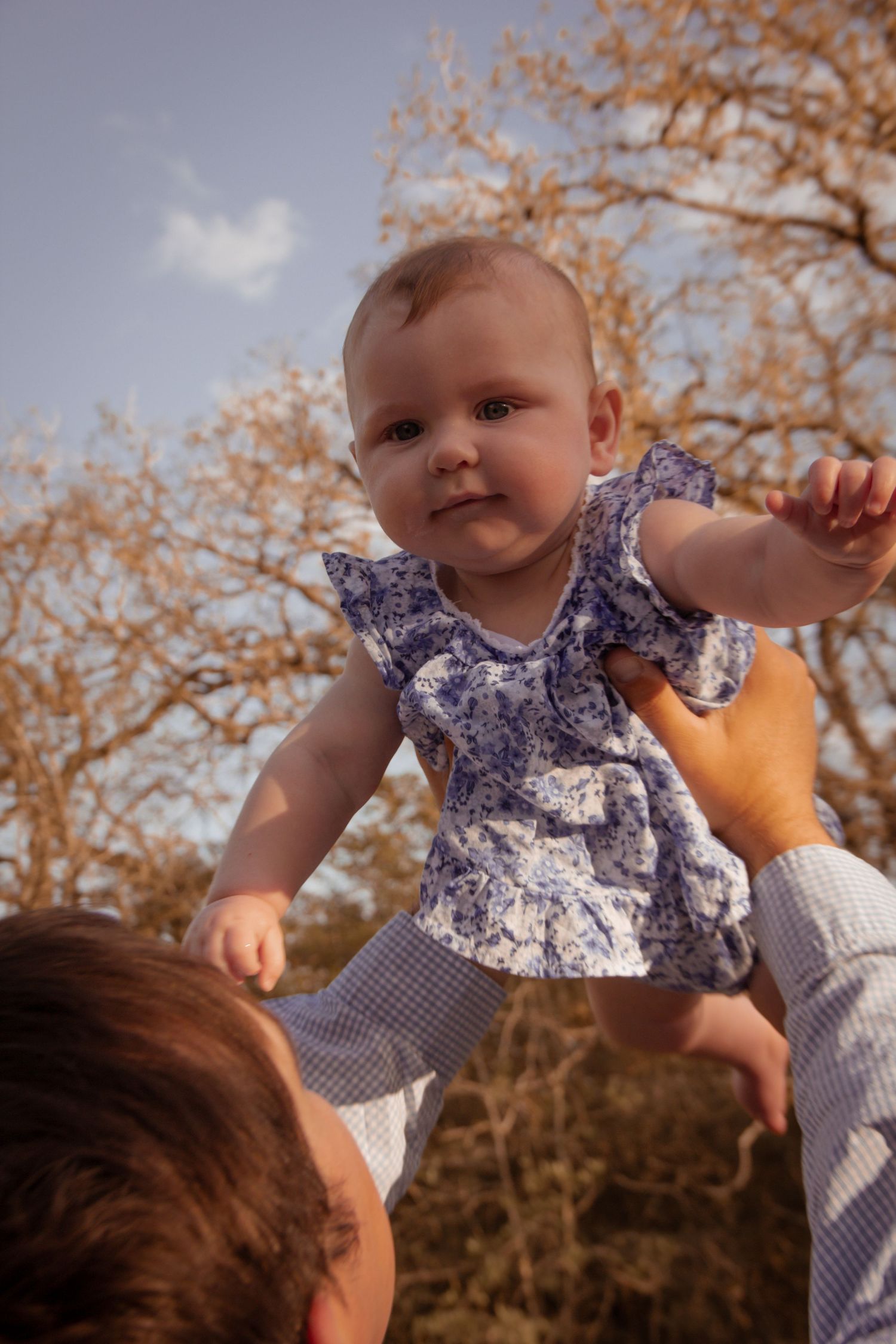 Baby being held by dad in family photos