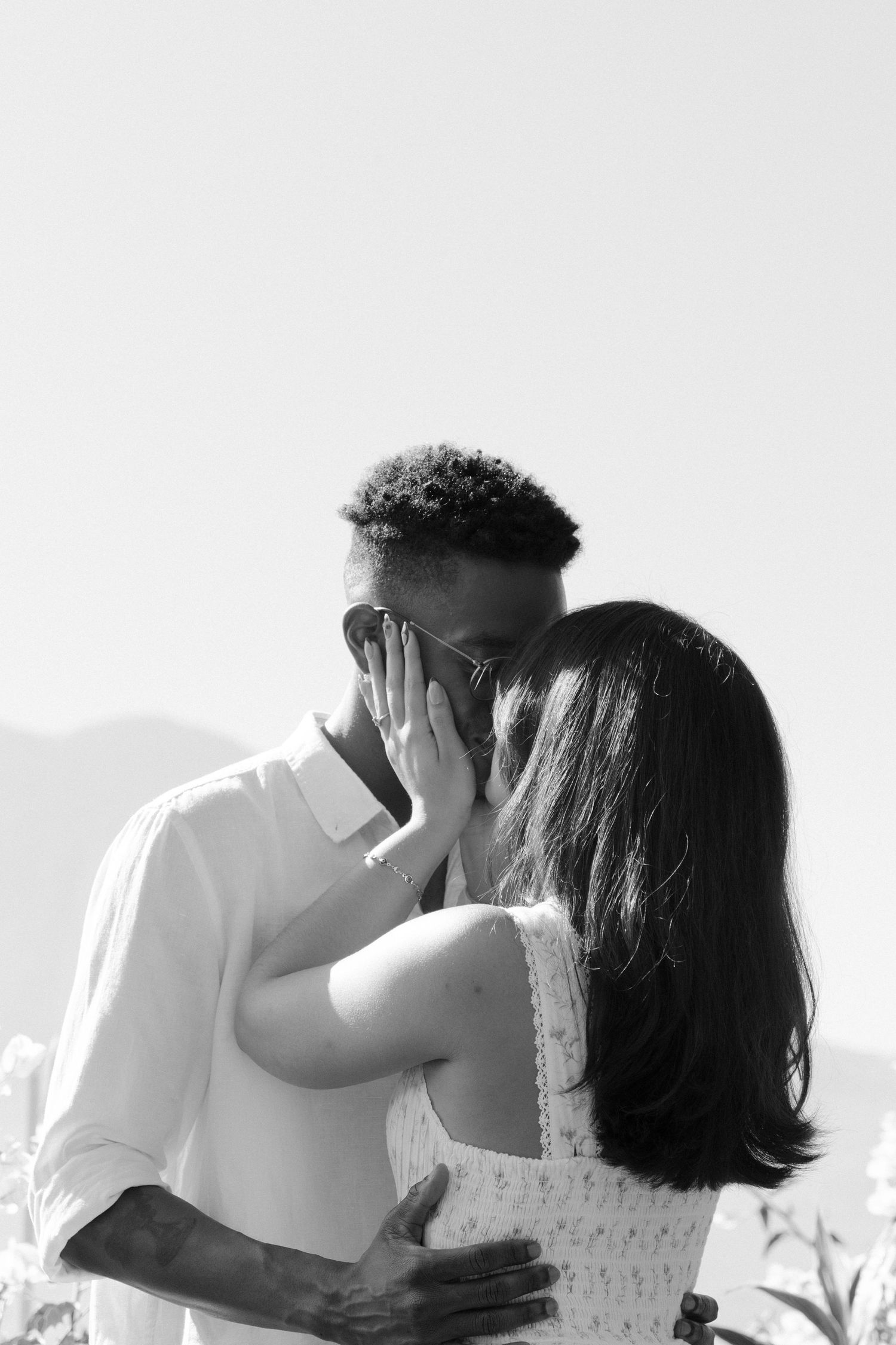 A sequence of romantic black and white photos showing a couple embracing and kissing.