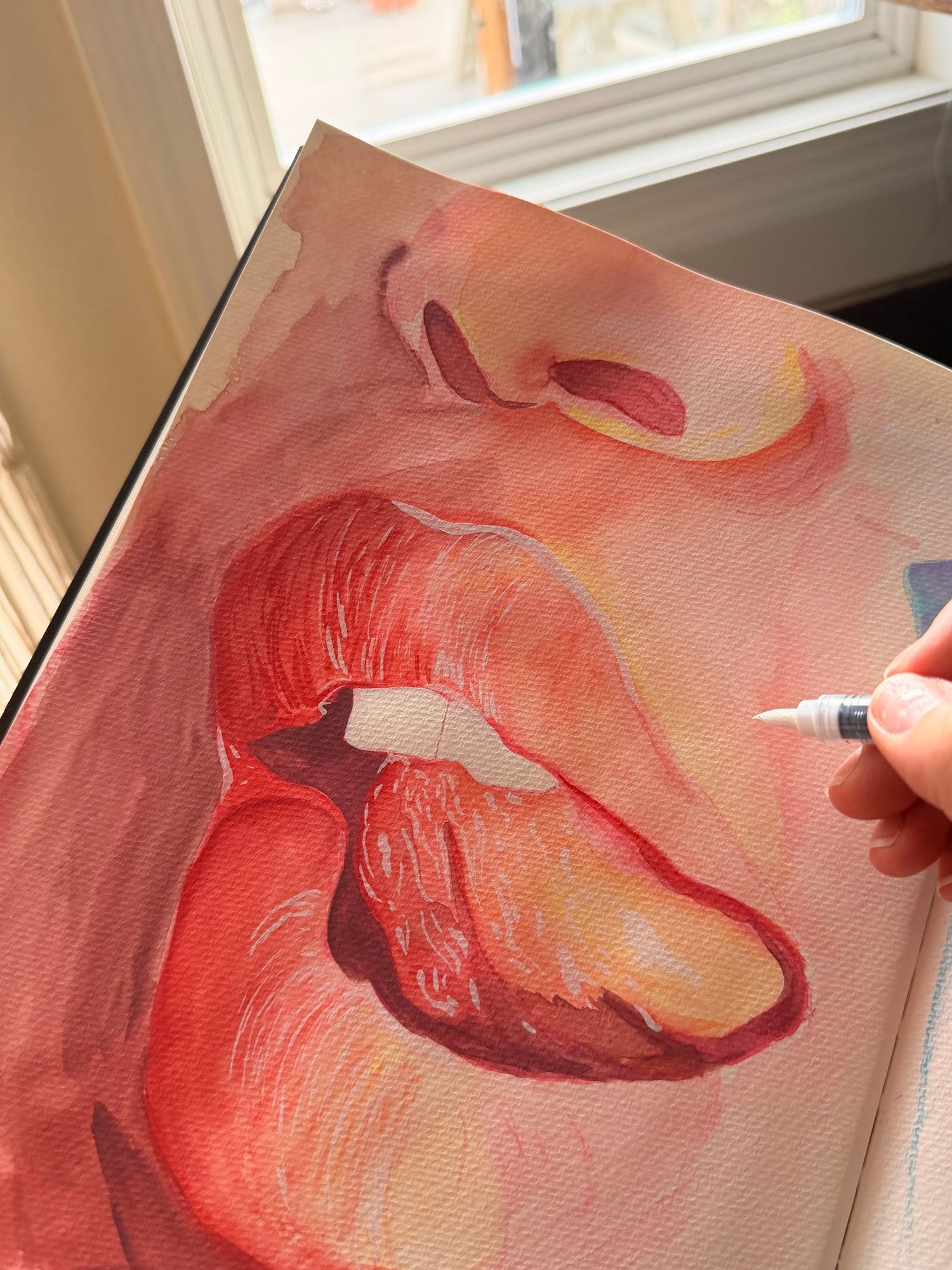 Artist adding white highlights to a close-up watercolor painting of lips and nose in warm red and pink tones.