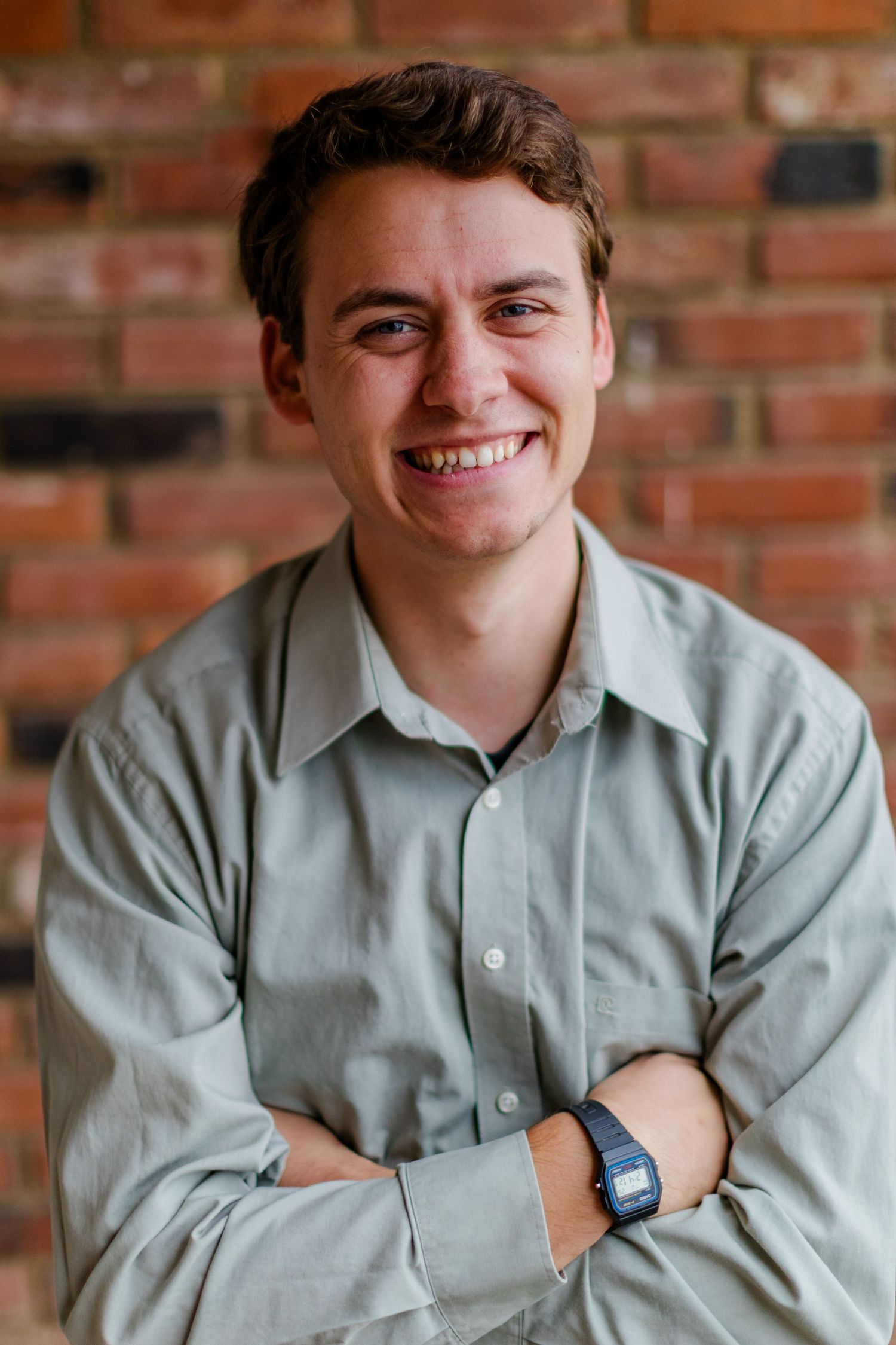 Indoor portrait series against brick wall showing various expressions and poses.