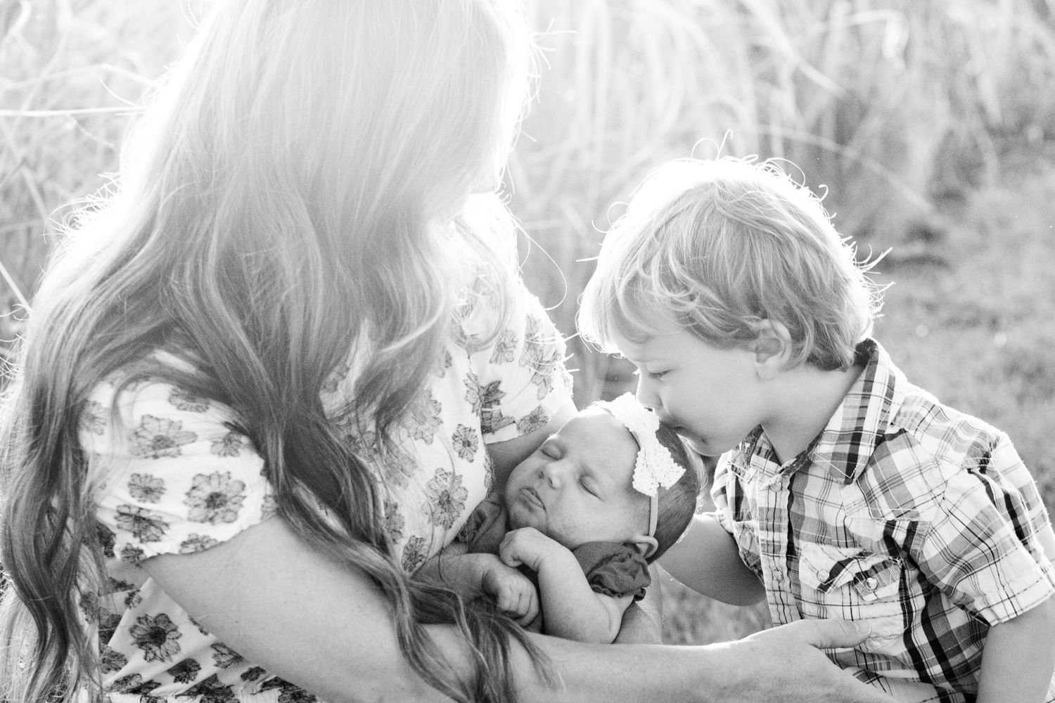 Black and white intimate family portrait series showing tender moments.