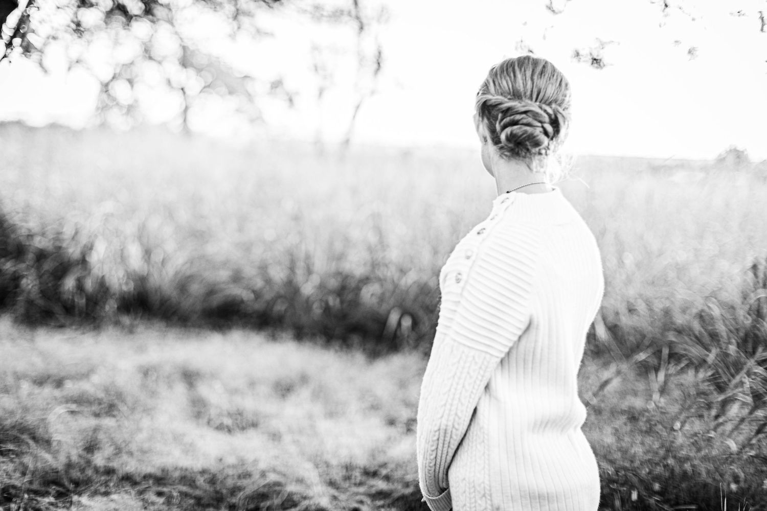 Black and white portraits of someone playing violin outdoors.