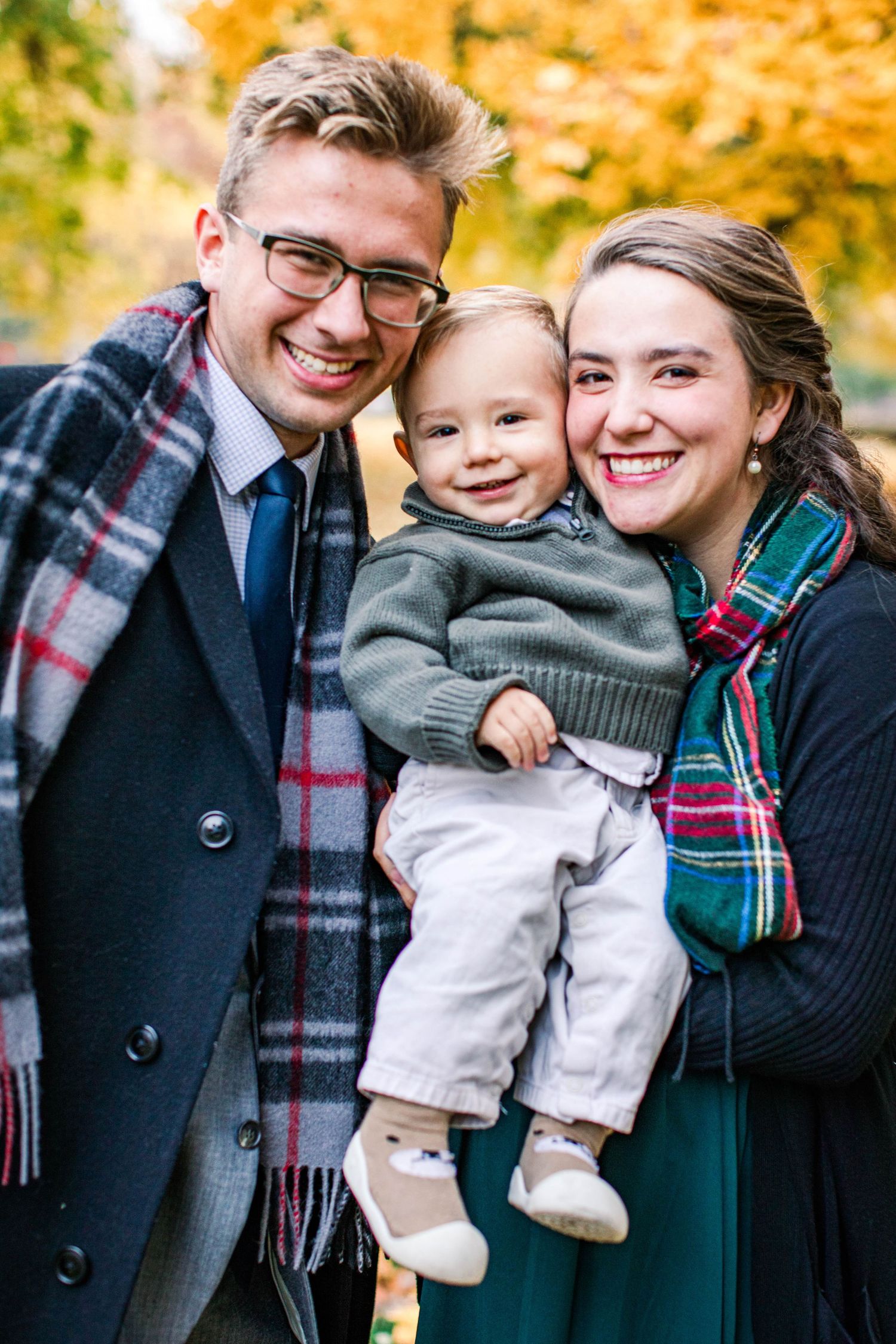 Family portrait series with autumn foliage showing parents and child in warm clothing.