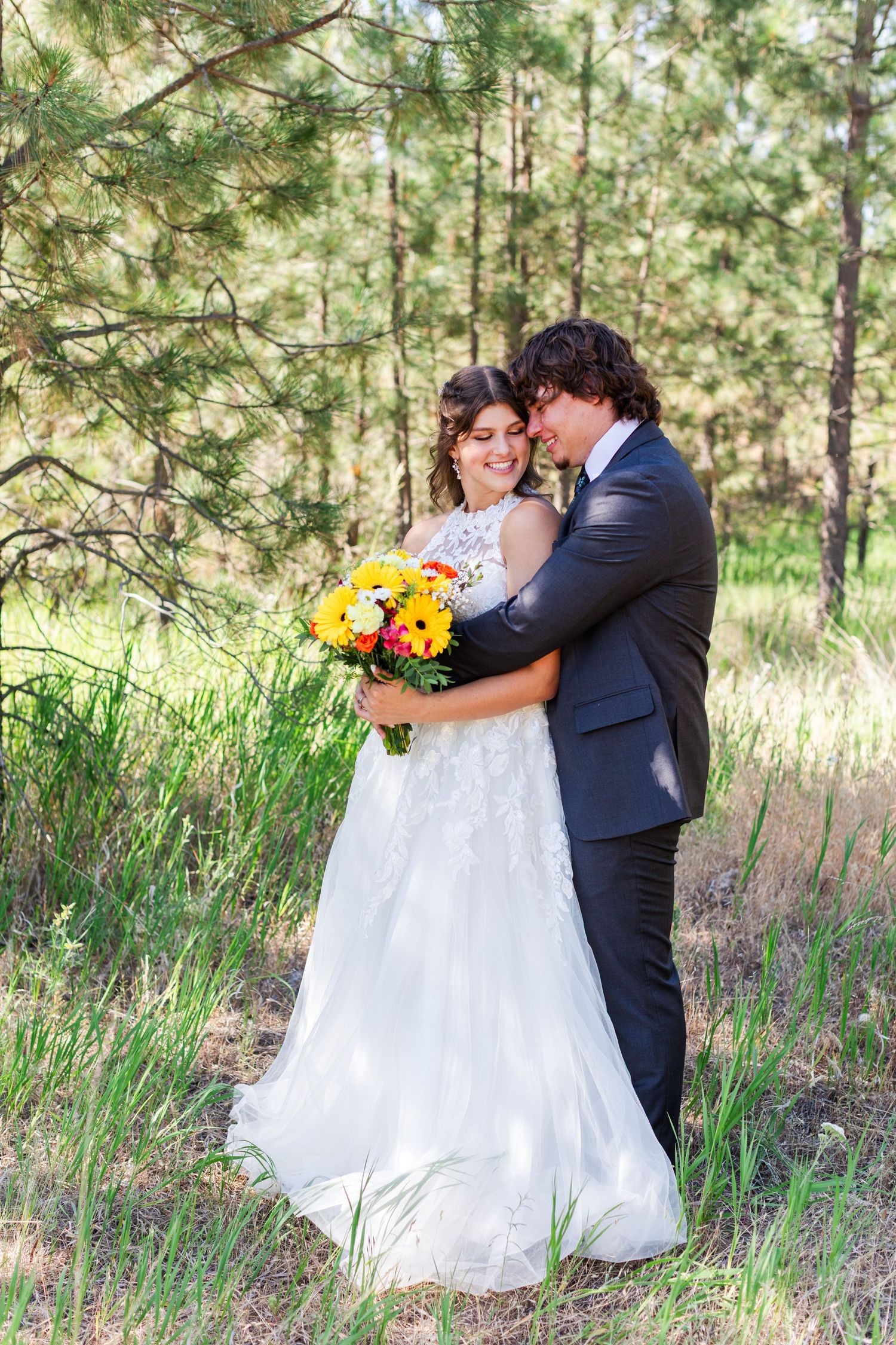 Romantic wedding photos captured in a serene pine forest setting.