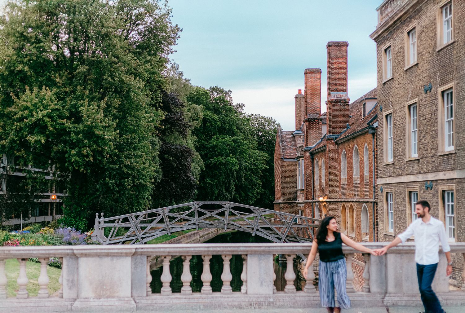 Classical architecture with a scenic bridge over water at a historic university campus.