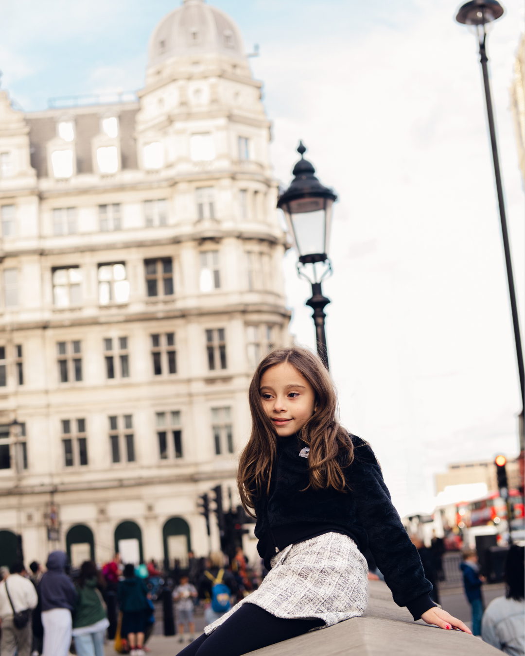 Street scene in front of historic Victorian architecture in London's city center.