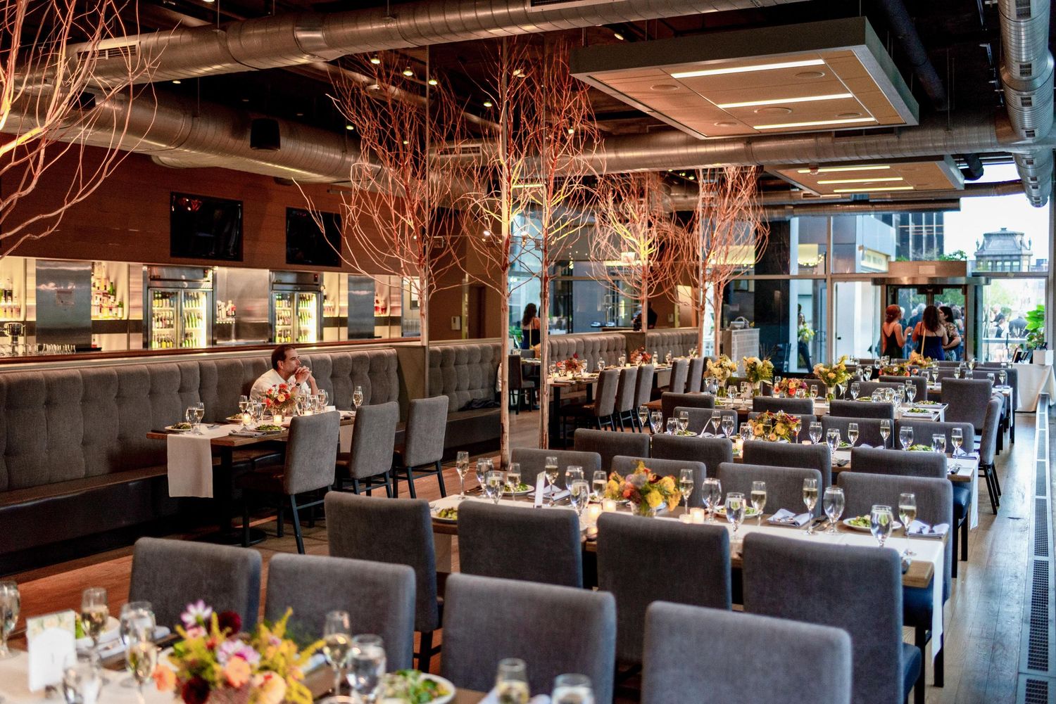 Modern restaurant dining room with ambient lighting and sophisticated table settings.
